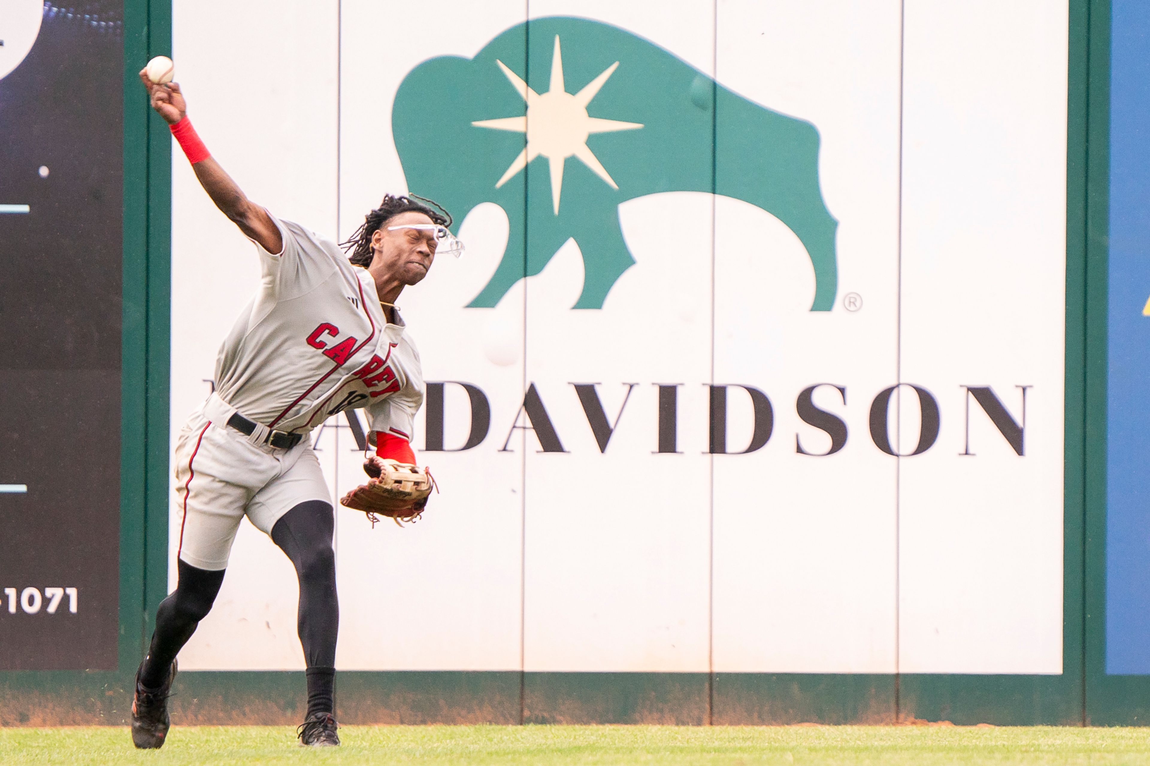 William Carey center fielder Jerod Williams loses his glasses as he throws the ball to the infield during game 6 of the NAIA World Series against Cumberlands on Saturday at Harris Field in Lewiston.