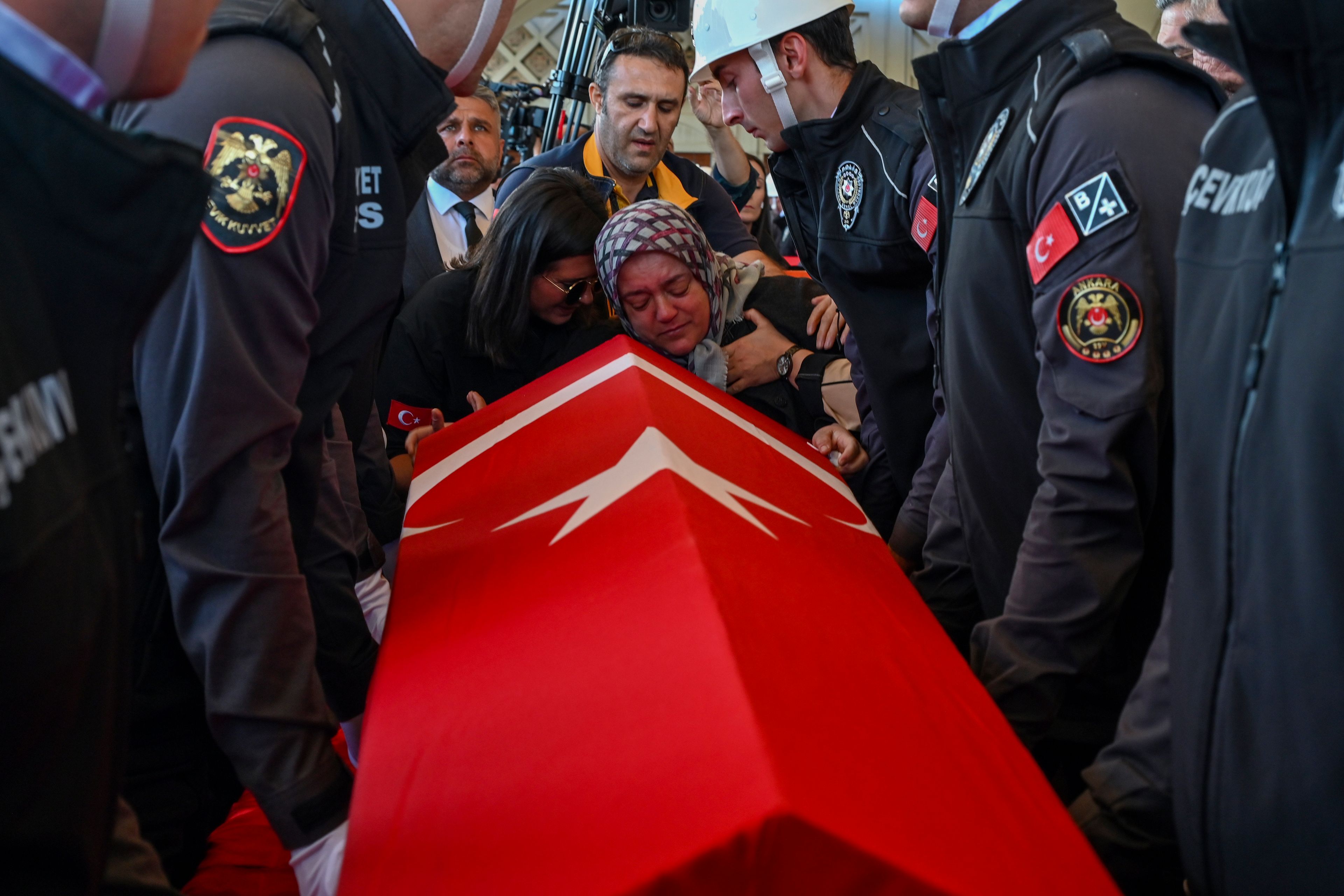 Relatives of Hasan Huseyin Canbaz, who was killed during an attack by PKK members at the Turkish aerospace and defense company TUSAS on Wednesday, mourn during a funeral at Karsiyaka mosque in Ankara, Thursday, Oct. 24, 2024. (AP Photo/Ali Unal)