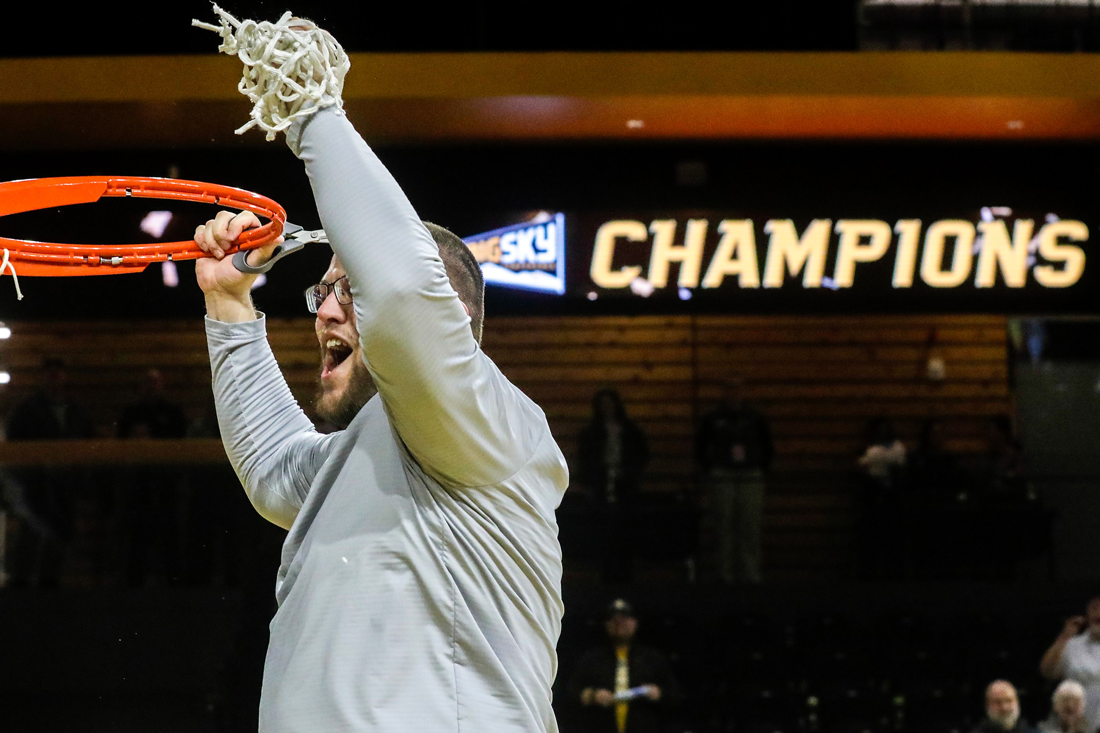 Idaho women’s basketball coach Arthur Moreira cuts the net after a Big Sky Conference game Feb. 28 at the ICCU Arena in Moscow.