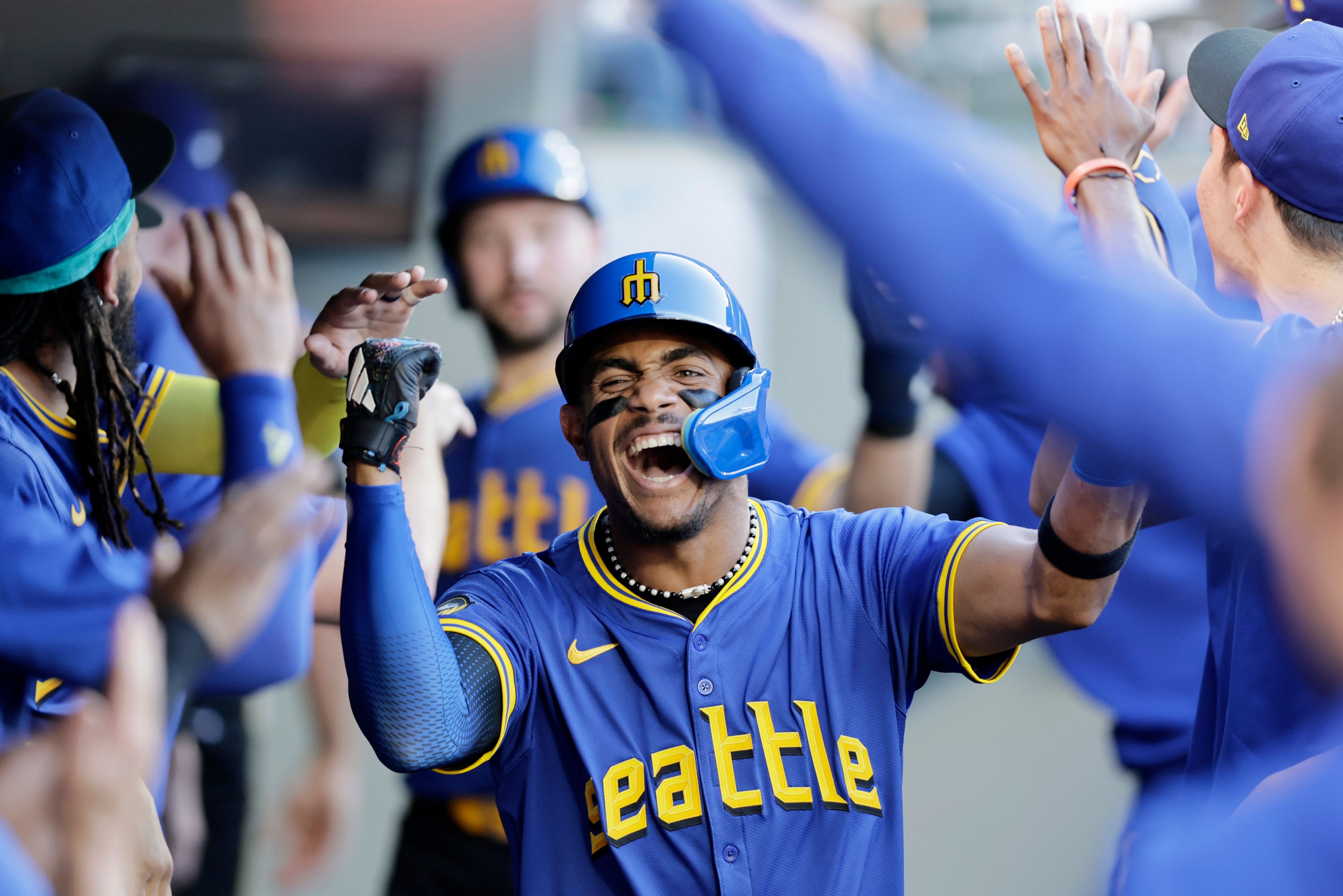 Seattle Mariners' Julio Rodriguez celebrates in the dugout after scoring against the Toronto Blue Jays in a baseball game, Friday, July 5, 2024, in Seattle. (AP Photo/John Froschauer)