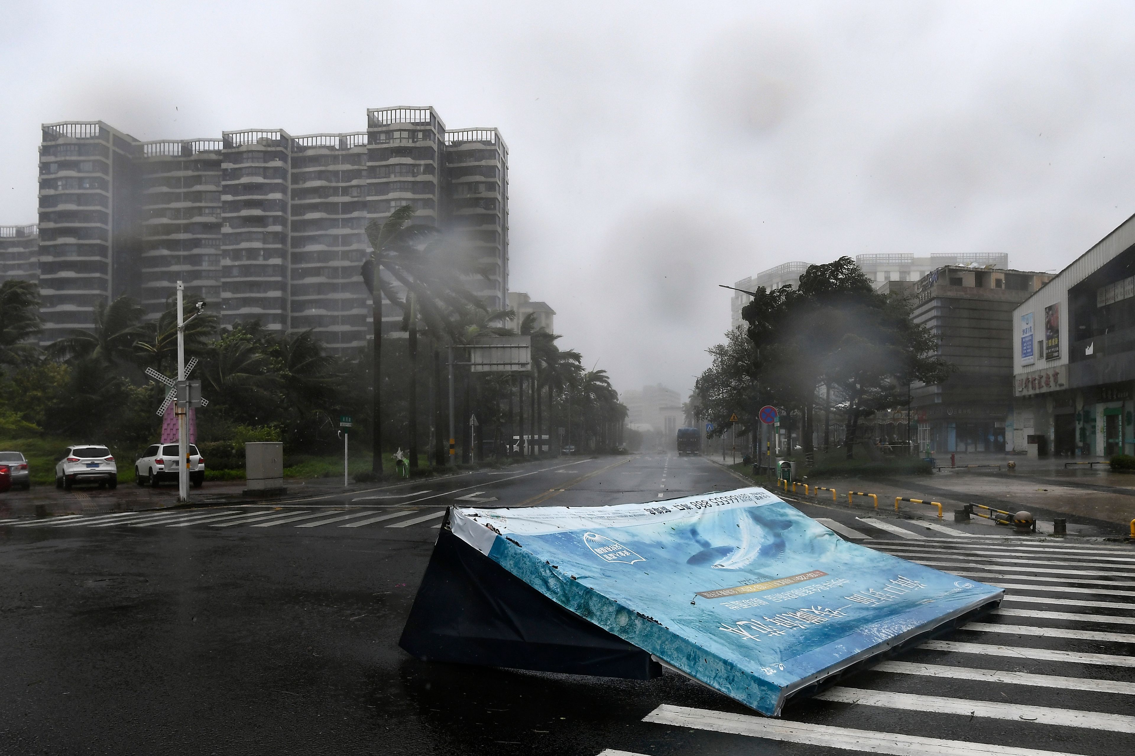 In this photo released by Xinhua News Agency, an advertisement billboard lands on a road following the landfall of typhoon Yagi in Haikou, south China's Hainan Province, Friday, Sept. 6, 2024.