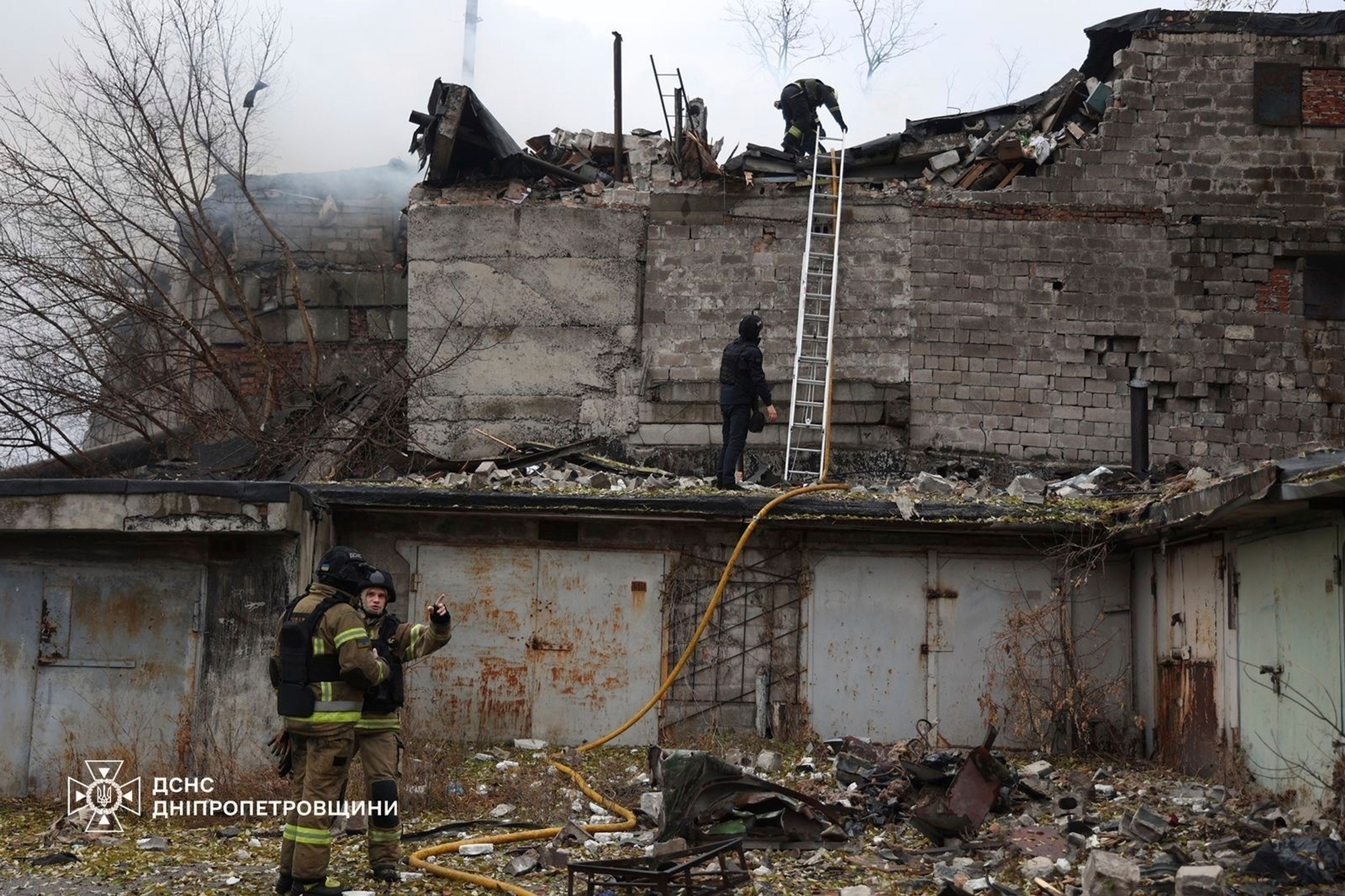 In this photo provided by the Ukrainian Emergency Services on Nov. 21, 2024, rescue workers put out a fire of a building which was heavily damaged by a Russian strike on Dnipro, Ukraine. (Ukrainian Emergency Service via AP)