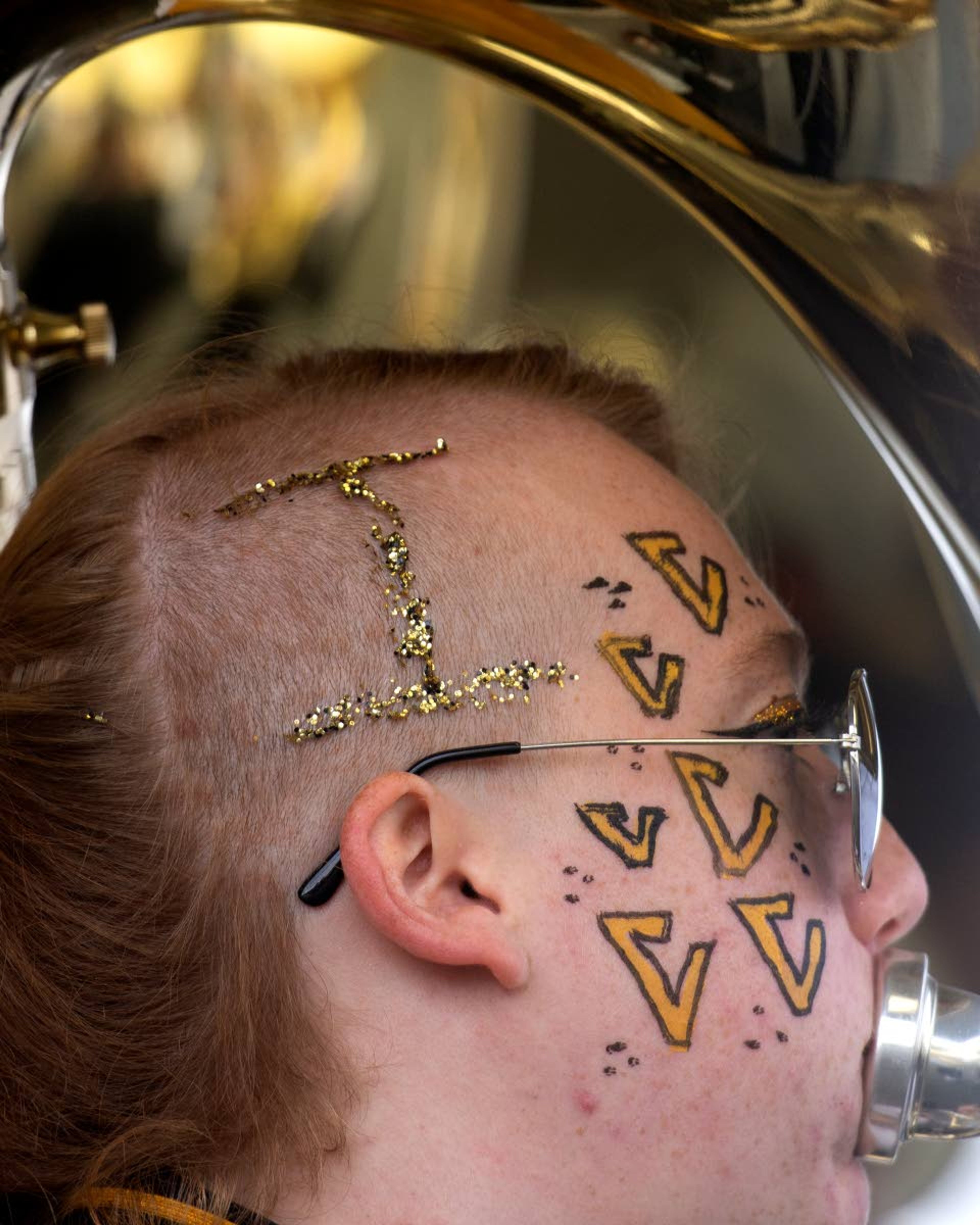 With Vandal spirit panted across the right side of her face, Erin Stewart, 20, performs along with her fellow sousaphone players at a tailgate on Saturday, Nov. 3.