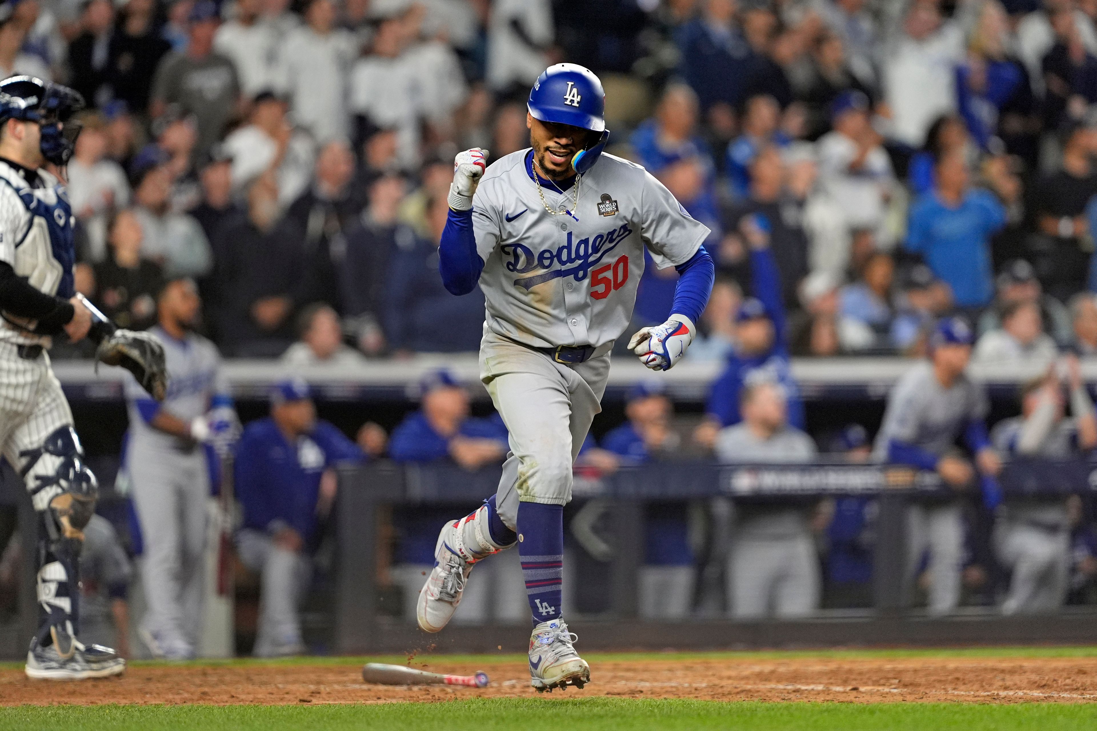 Los Angeles Dodgers' Mookie Betts (50) celebrates after hitting a sacrifice fly against the New York Yankees during the eighth inning in Game 5 of the baseball World Series, Wednesday, Oct. 30, 2024, in New York. (AP Photo/Godofredo A. VÃ¡squez)