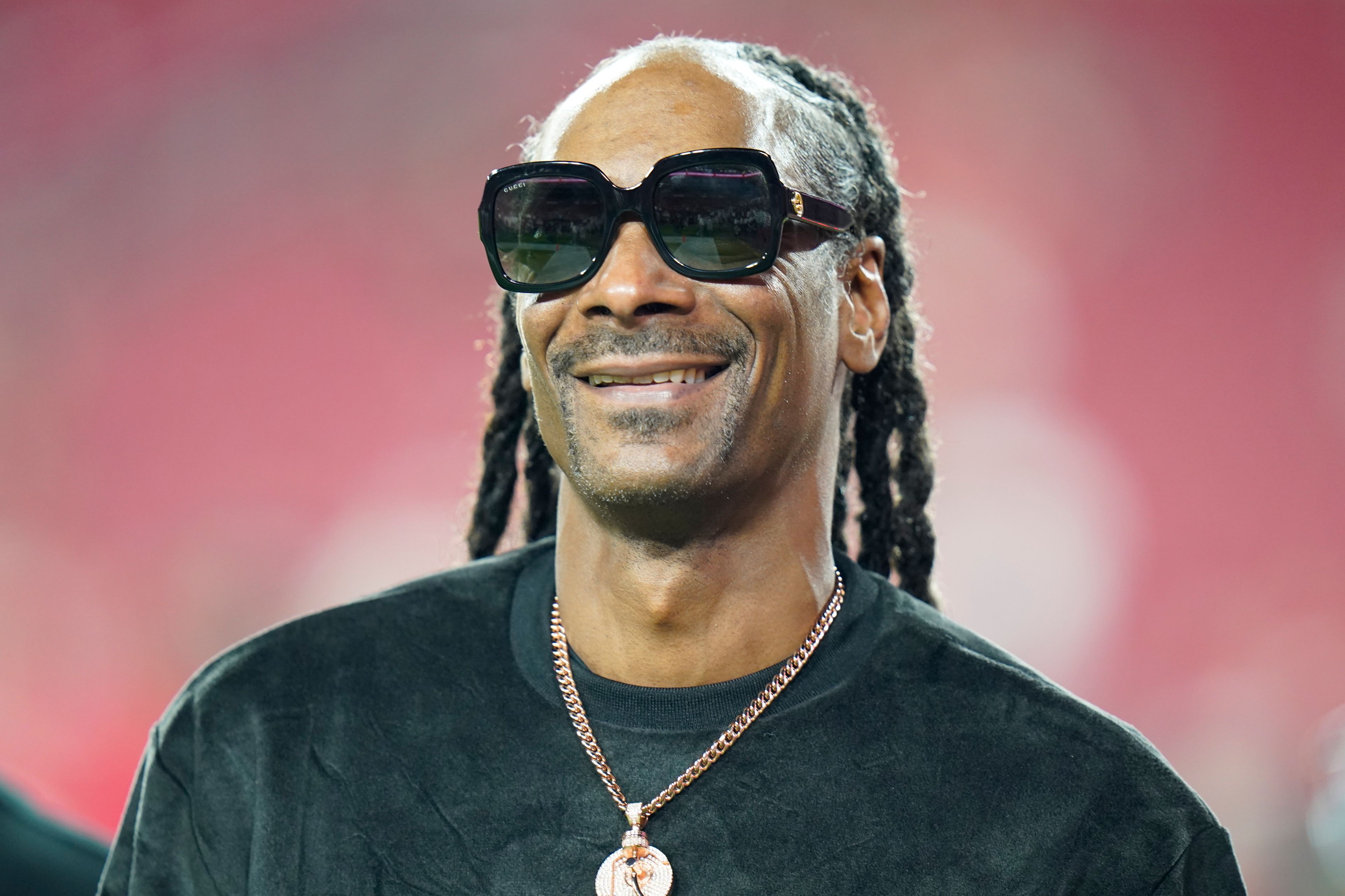 FILE - Entertainer Snoop Dogg walks on the field before an NFL football game between the Tampa Bay Buccaneers and the New Orleans Saints Sunday, Dec. 19, 2021, in Tampa, Fla. Snoop Dogg will serve as a primetime NBC correspondent for Paris Olympics.