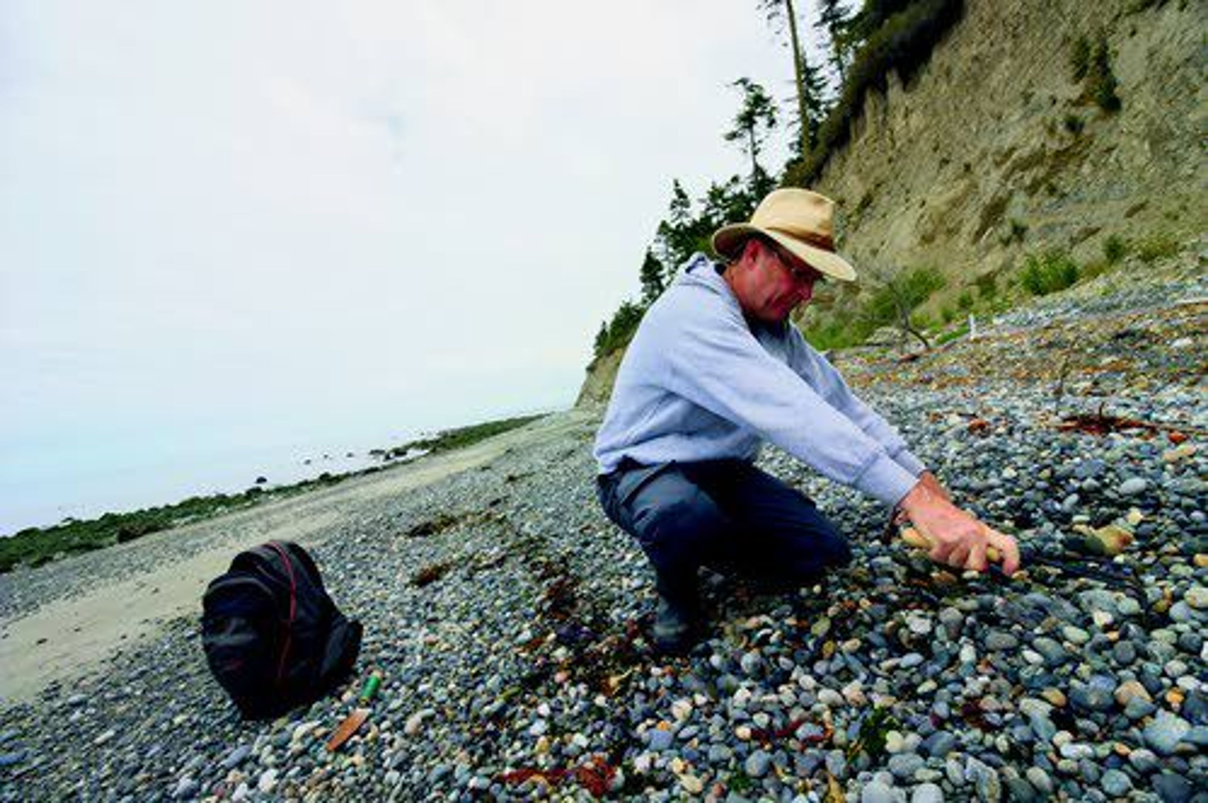 Tim Blair rakes a rock bed on Glass Beach as he looks for sea glass in Port Townsend, Wash., July 21.