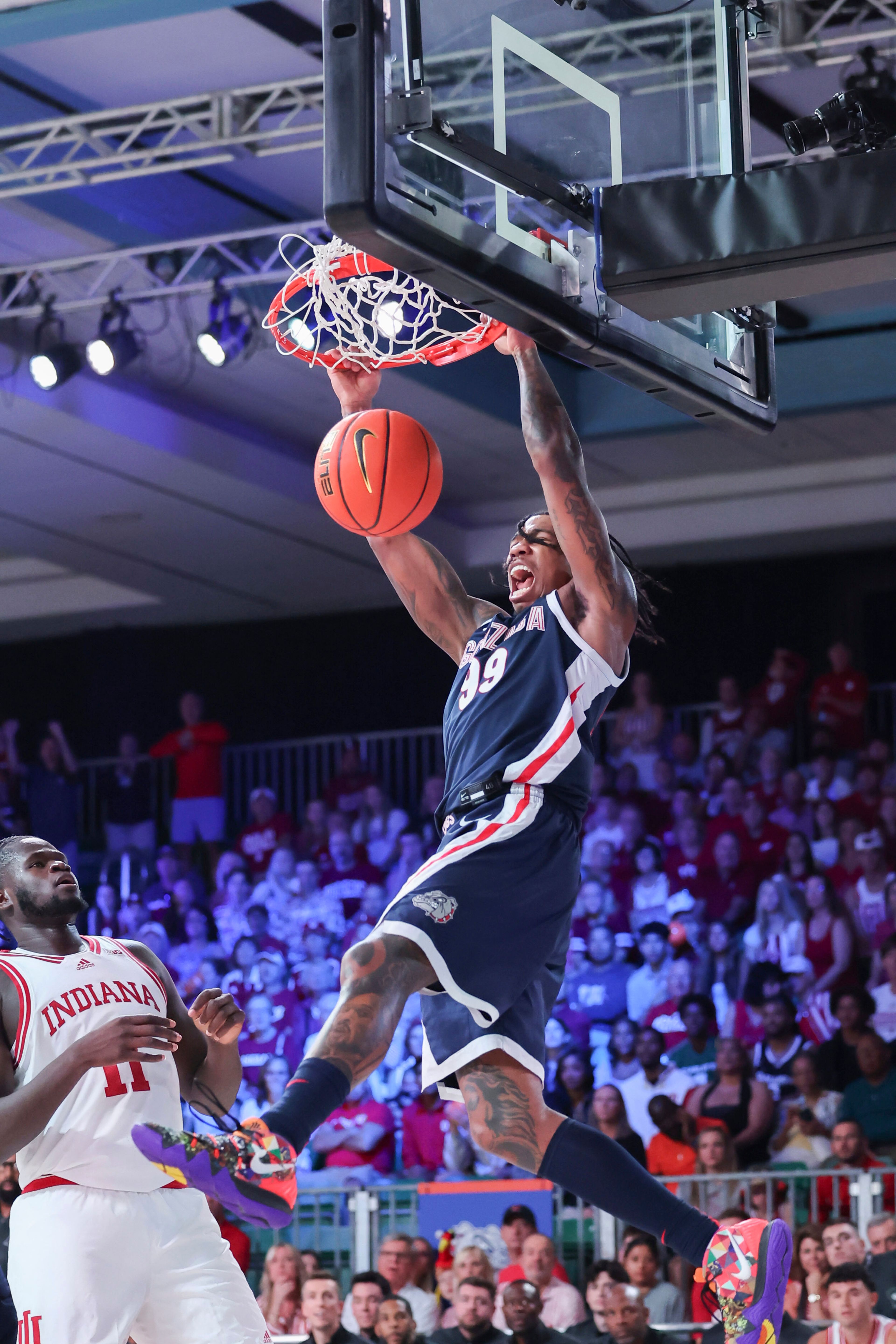 In this photo provided by Bahamas Visual Services, Gonzaga's Khalif Battle dunks over Indiana's Oumar Ballo during an NCAA college basketball game Thursday, Nov. 28, 2024, in Paradise Island, Bahamas. (Tim Aylen/Bahamas Visual Services via AP)