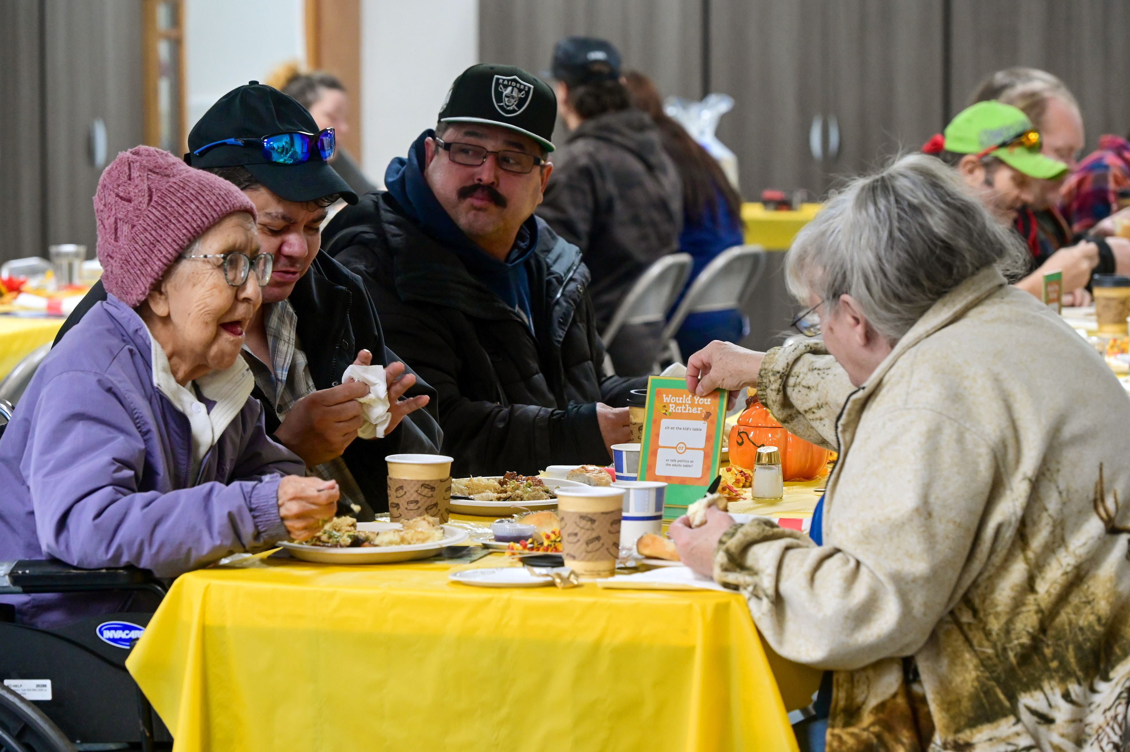 Doreen Woodin, left, eats Thanksgiving lunch with son Eugene Woodin, center, and Mo Baker, right, at the Salvation Army in the Lewis-Clark Valley on Thursday.