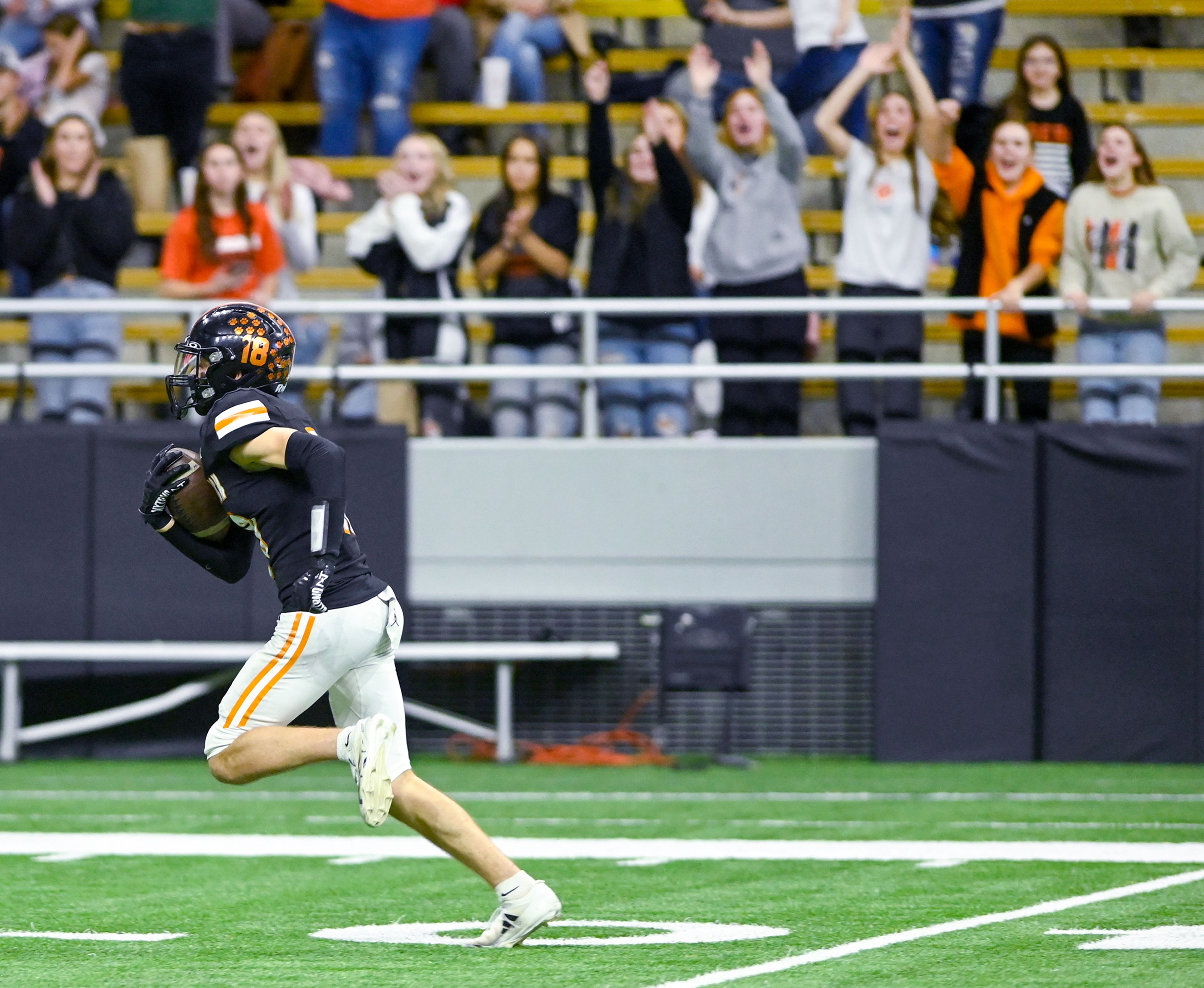 The crowd cheers for Kendrick’s Cade Silflow as he carries the ball down the field in a breakaway play against Butte County Friday during the Idaho 2A football state championship game at the P1FCU Kibbie Dome in Moscow.