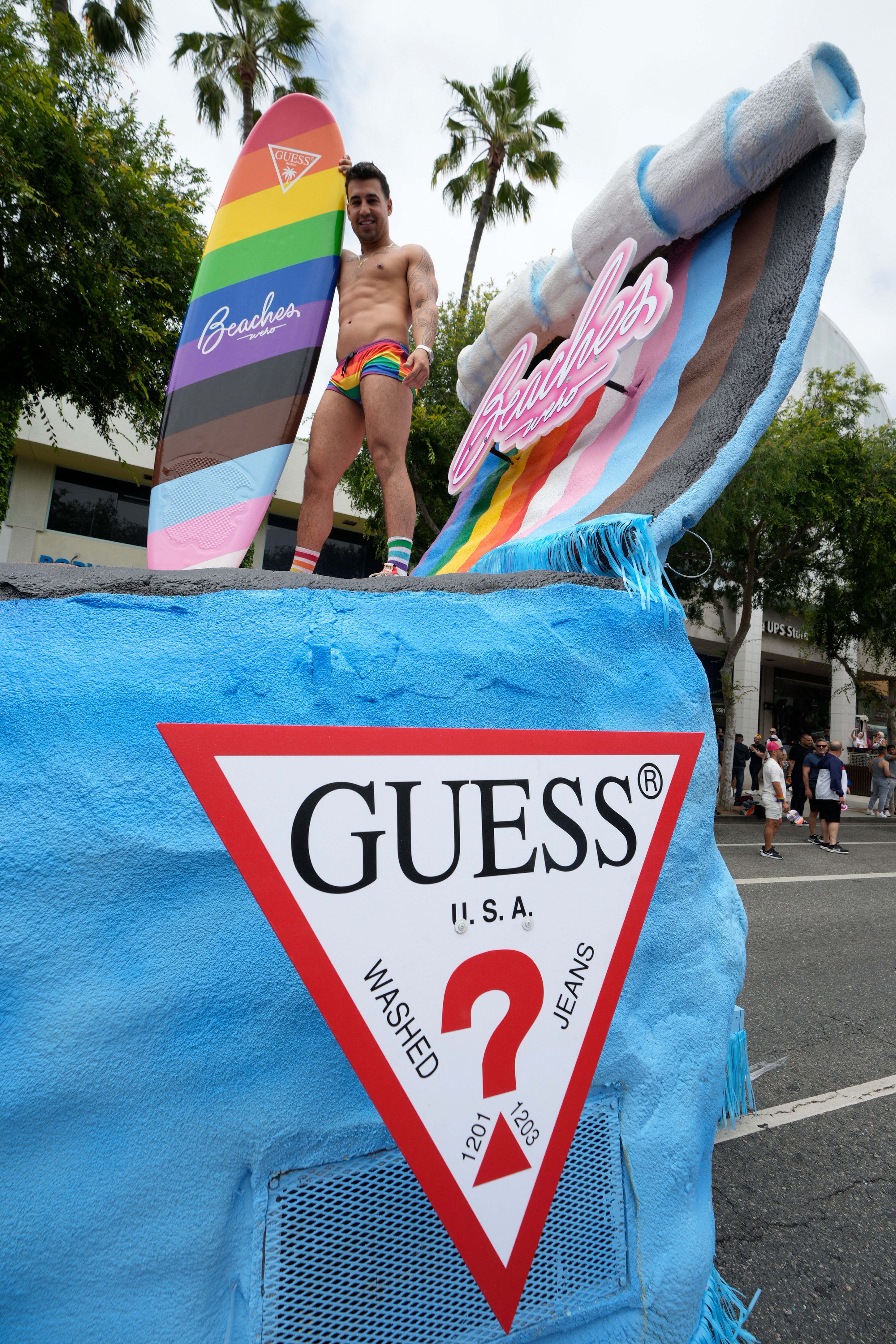 The apparel brand Guess is promoted on the Beaches WeHo entry at the WeHo Pride Parade in West Hollywood, Calif., on Sunday, June 4, 2023. (AP Photo/Damian Dovarganes)