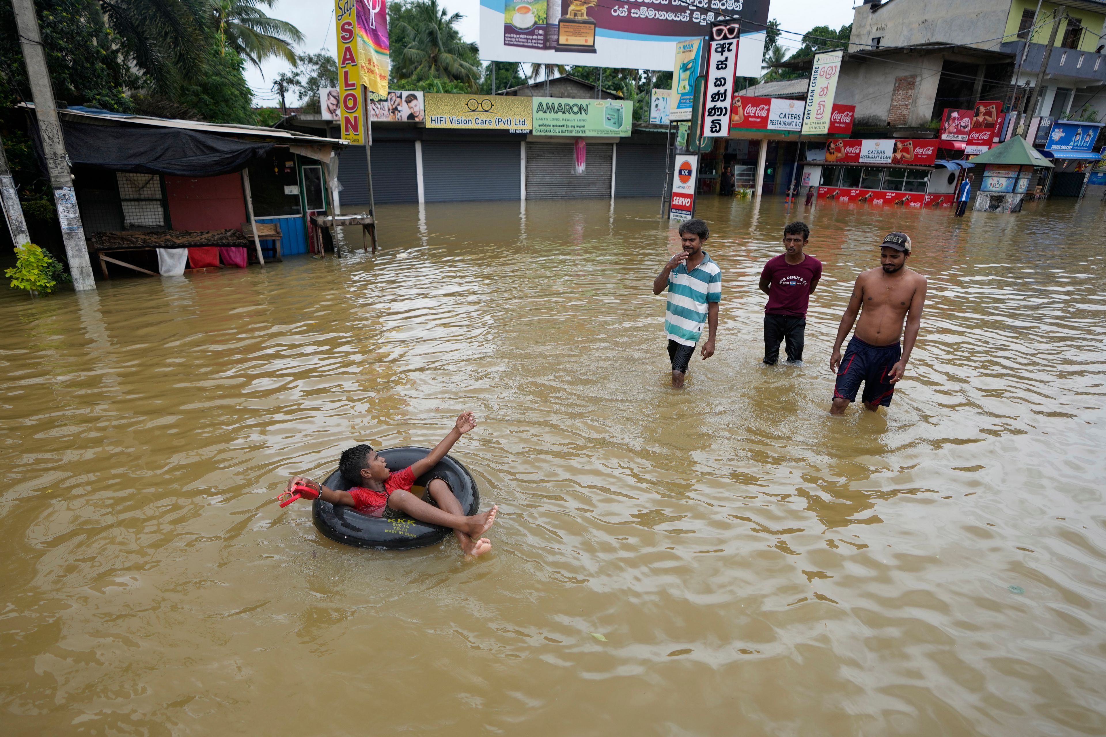 A boy plays with an inflatable rubber tube in a flooded street in Biyagama, a suburb of Colombo, Sri Lanka, Monday, Jun. 3, 2023. Sri Lanka closed schools on Monday as heavy rains triggered floods and mudslides in many parts of the island nation, killing at least 10 people while six others have gone missing, officials said.