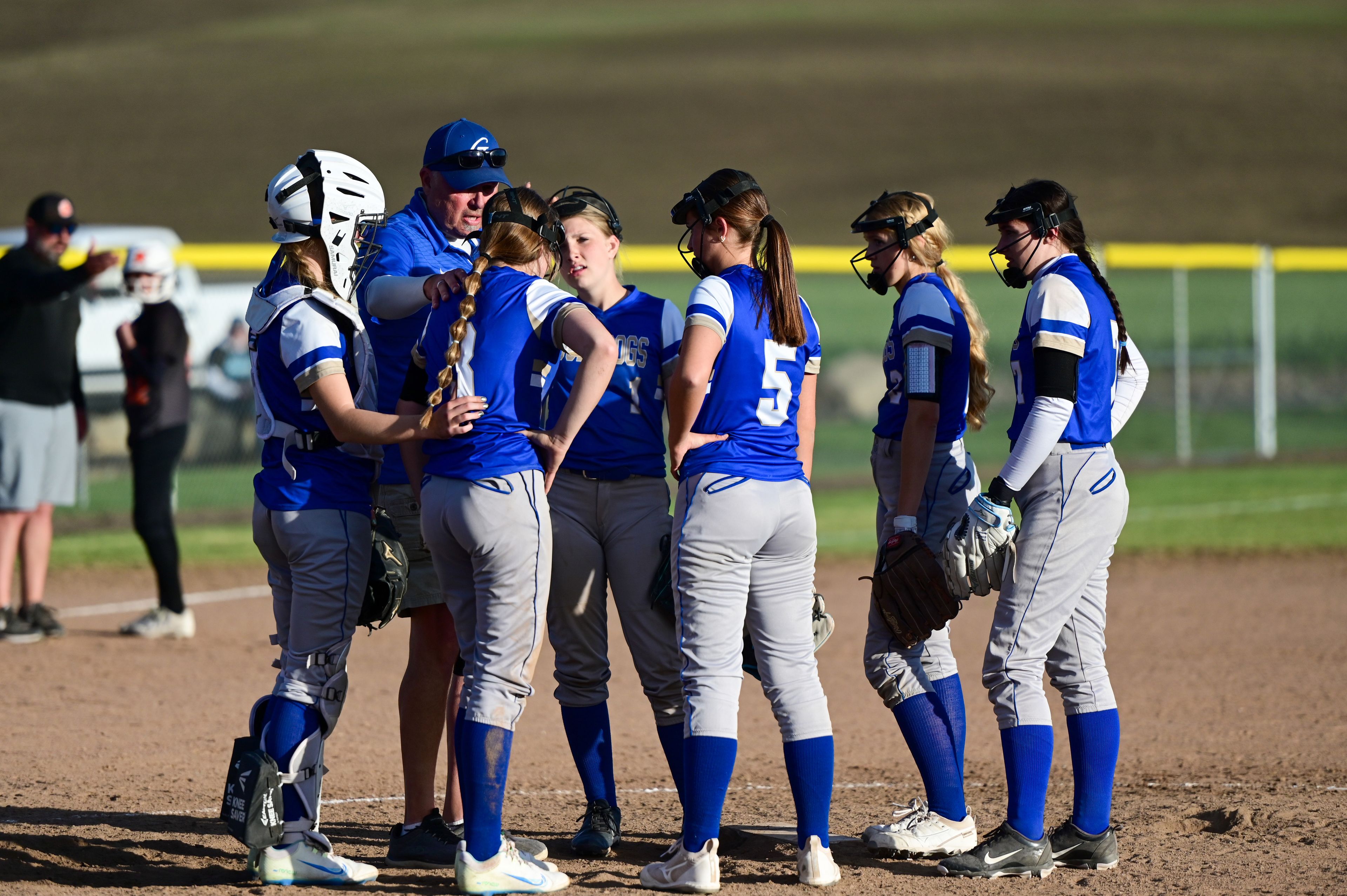 Genesee players huddle up with their coach during an Idaho 2A district tournament championship game Wednesday in Genesee.