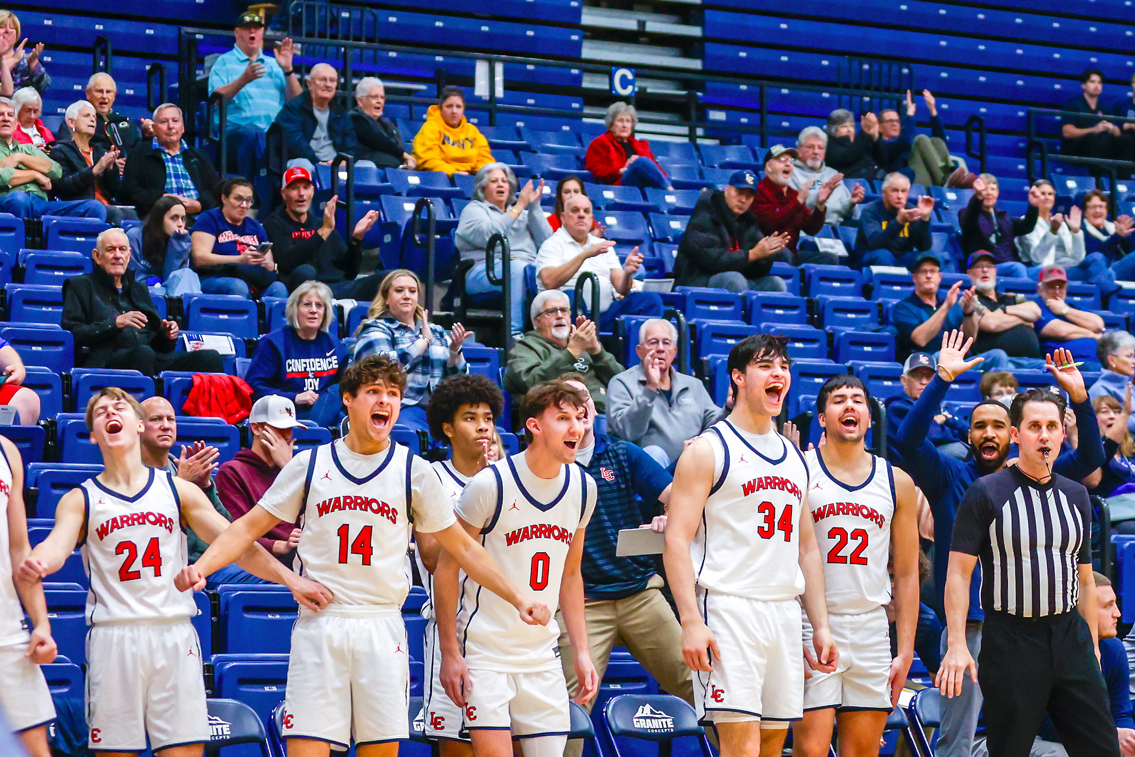 The Lewis-Clark State bench cheers as John Lustig dunks the ball against Walla Walla during a quarter of a Cascade Conference game Tuesday at Lewis-Clark State College in Lewiston.