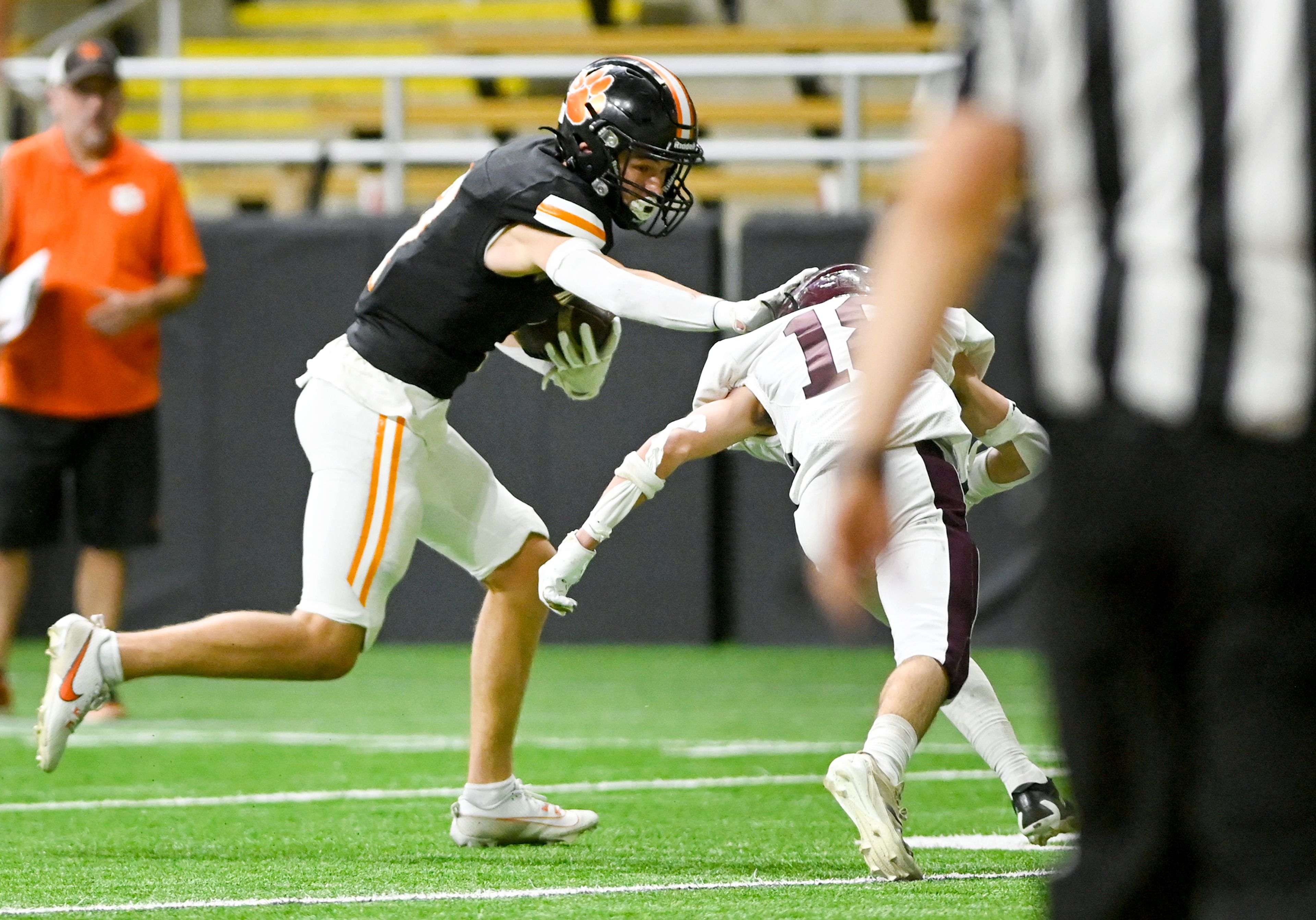 Kendrick’s Ralli Roetcisoender pushes past Kamiah’s Todd Roberts, carrying the ball to the end zone for a touchdown during an Idaho Class 2A state quarterfinal game at the P1FCU Kibbie Dome in Moscow.