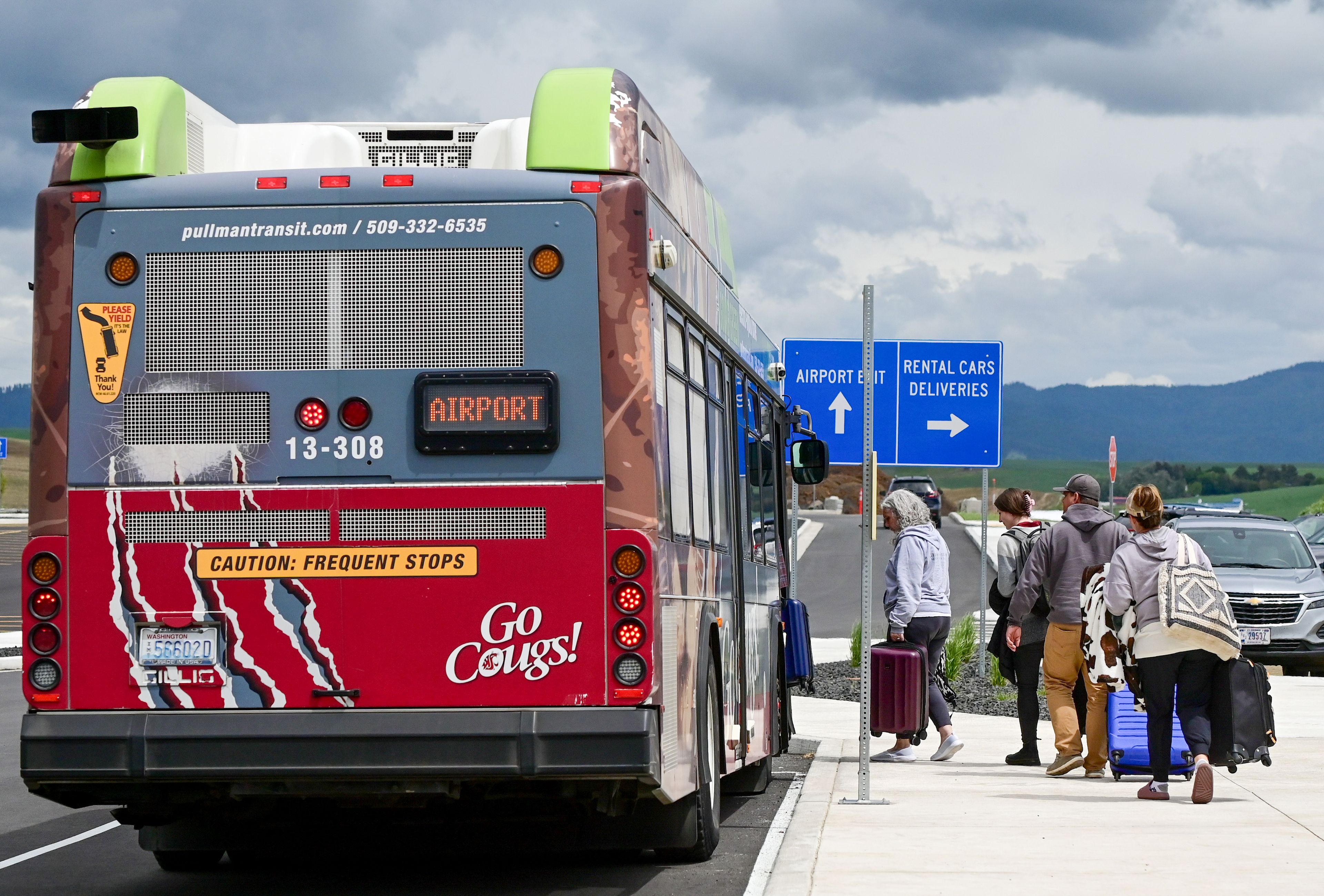 A bus transports those arriving at the new Pullman-Moscow Regional Airport terminal to their cars at the old terminal on Wednesday.