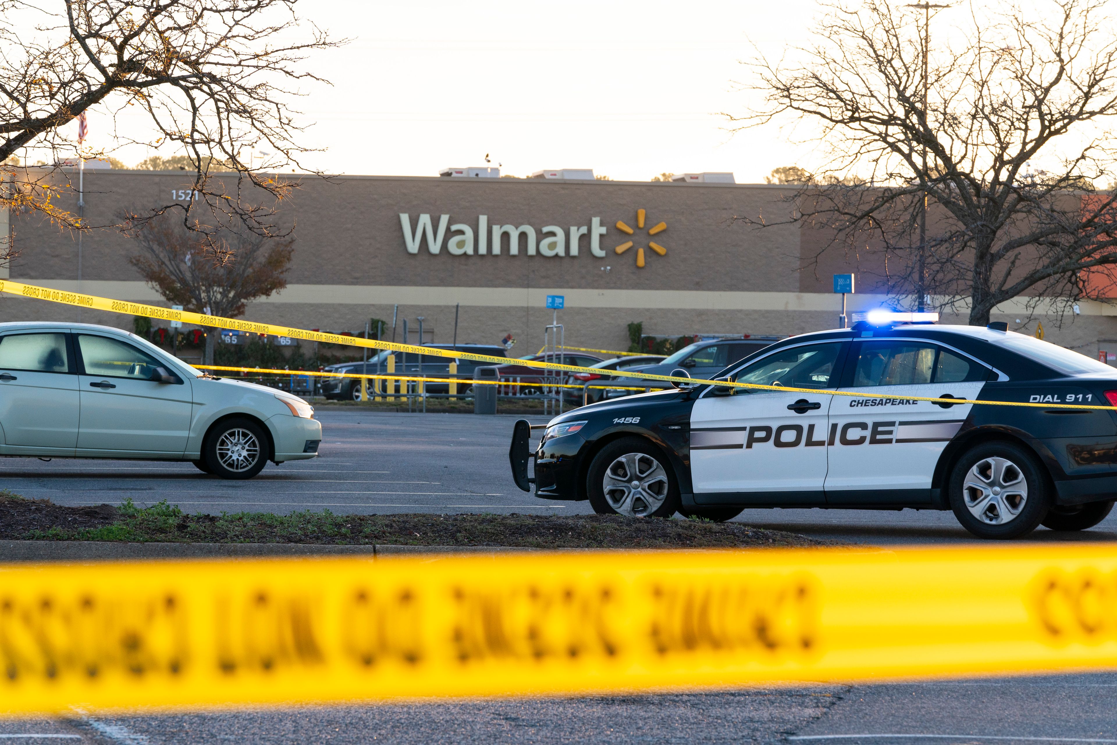 Law enforcement work the scene of a mass shooting at a Walmart, Wednesday, Nov. 23, 2022, in Chesapeake, Va. The store was busy just before the shooting Tuesday night with people stocking up ahead of the Thanksgiving holiday. (AP Photo/Alex Brandon)