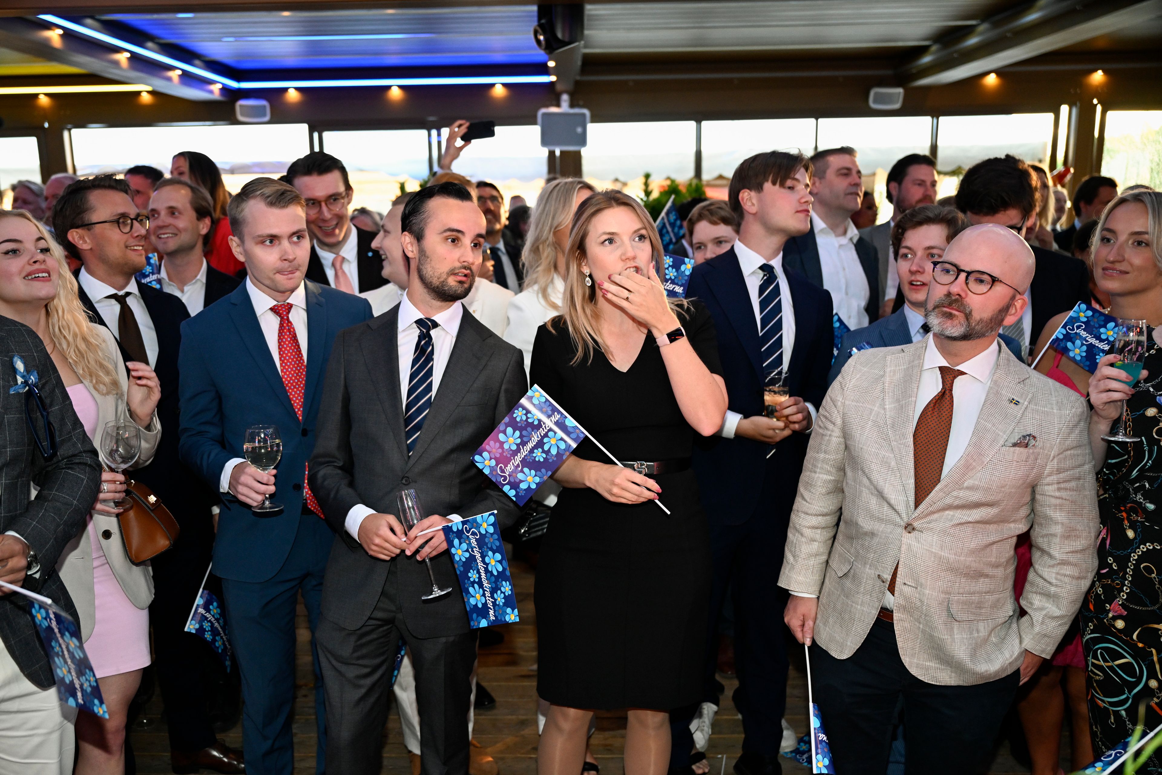 People look at incoming results at the Sweden Democrats' election watch event at restaurant Josefina on Djurgården in Stockholm, Sunday, June 9, 2024.