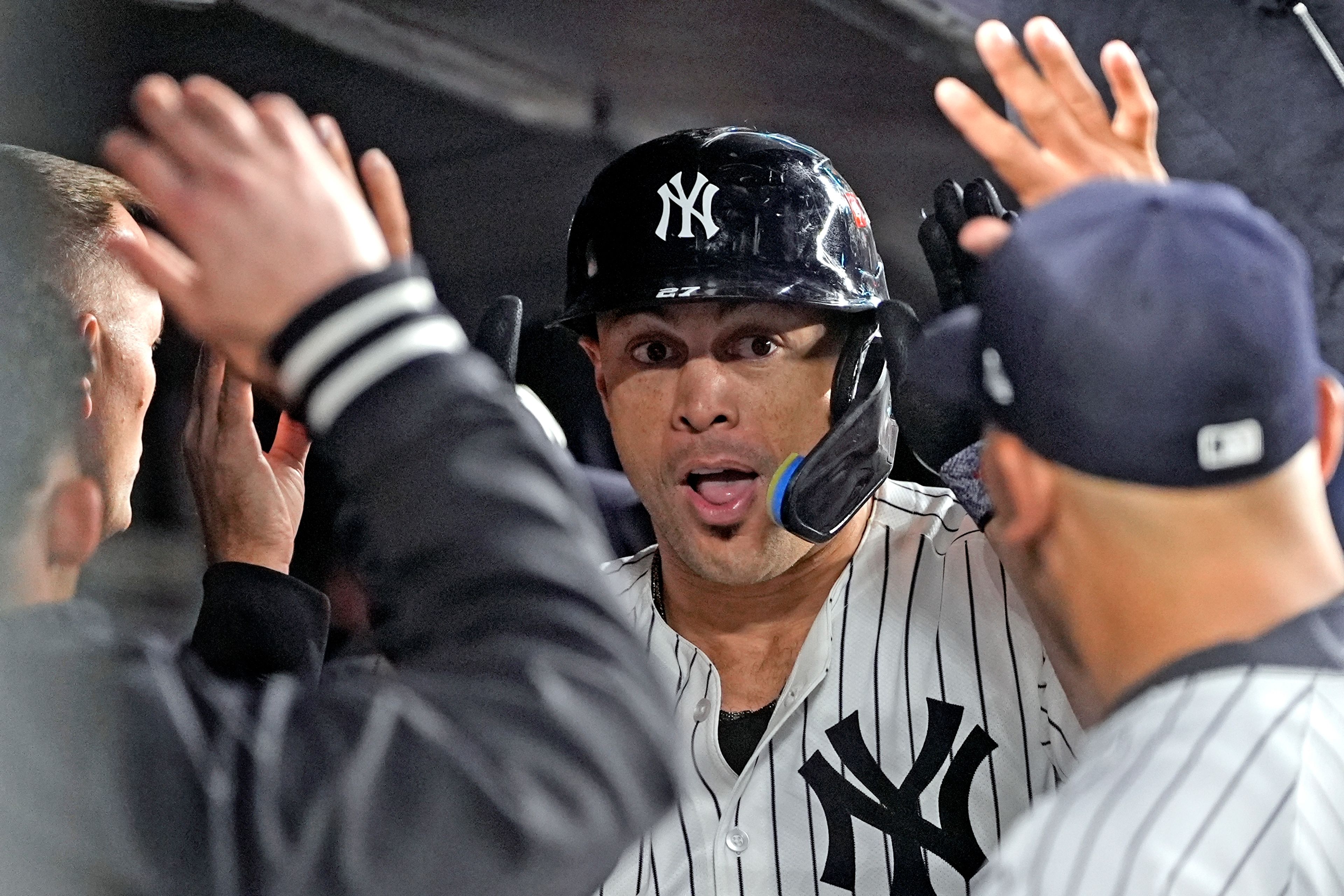 New York Yankees' Giancarlo Stanton celebrates in the dugout after hitting a home run against the Cleveland Guardians during the seventh inning in Game 1 of the baseball AL Championship Series Monday, Oct. 14, 2024, in New York. (AP Photo/Godofredo VÃ¡squez )