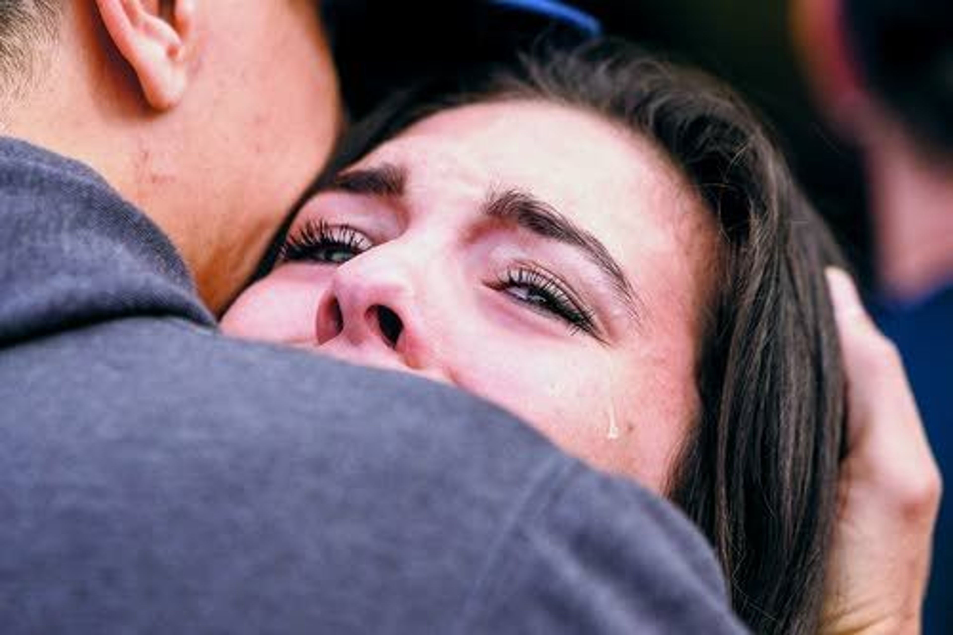 Tearful students reunite with friends and family at a church near the scene of Friday’s school shooting in Marysville, Wash.