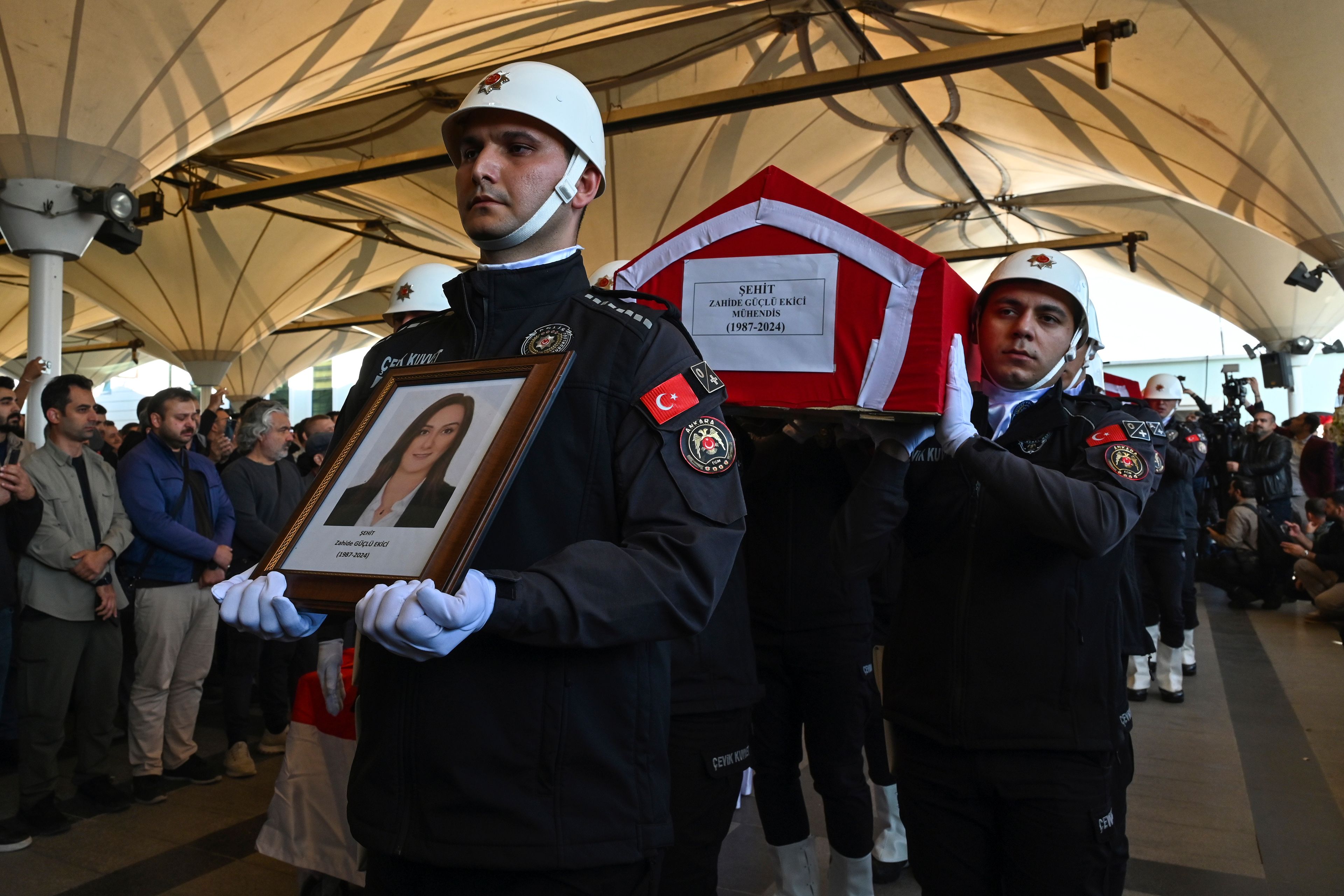 Turkish soldiers carry the coffin of Zahide Guglu Ekici, who was killed during an attack by PKK members at the Turkish aerospace and defense company TUSAS in Ankara on Wednesday, during a funeral at Karsiyaka mosque in Ankara, Thursday, Oct. 24, 2024. (AP Photo/Ali Unal)