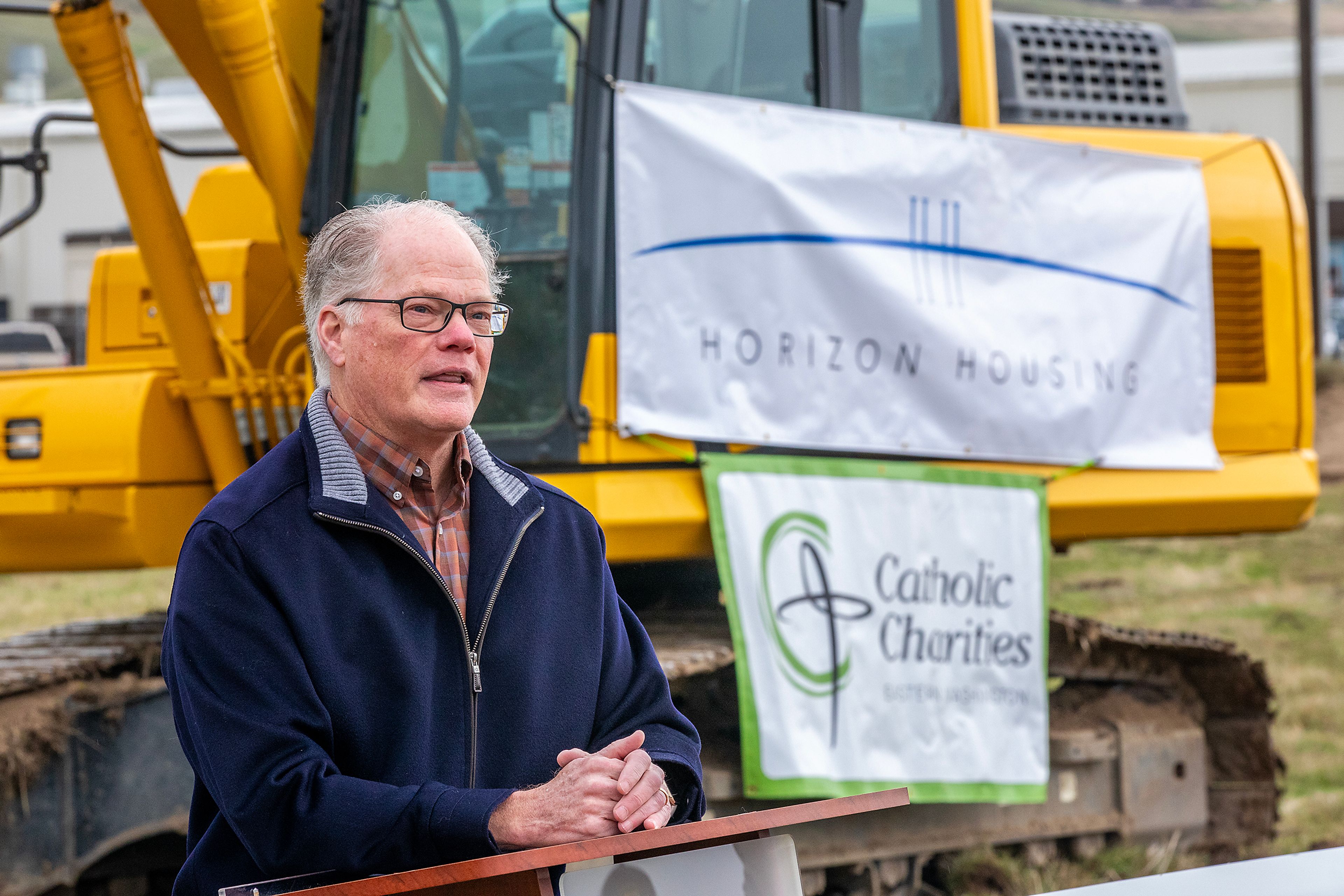 John Pilcher, Horizon Housing Alliance executive director, speaks at the groundbreaking for the new apartments that will be built in the empty field off of Port Drive next to Walmart on Monday in Clarkston.