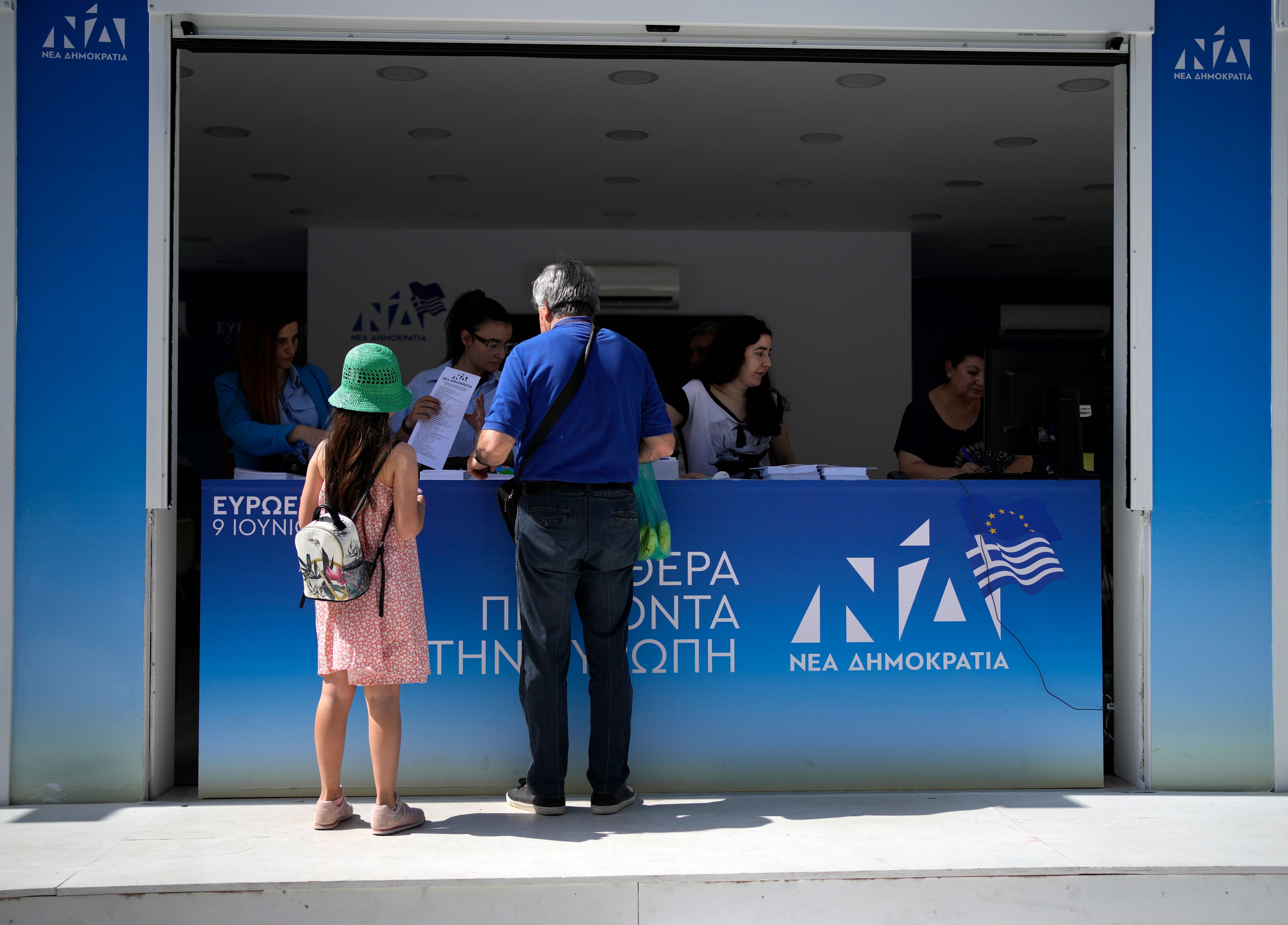 A man stands at an election kiosk of the ruling party of New Democracy in Athens, Greece, Friday, June 7, 2024. The European Election will take place on June 9.