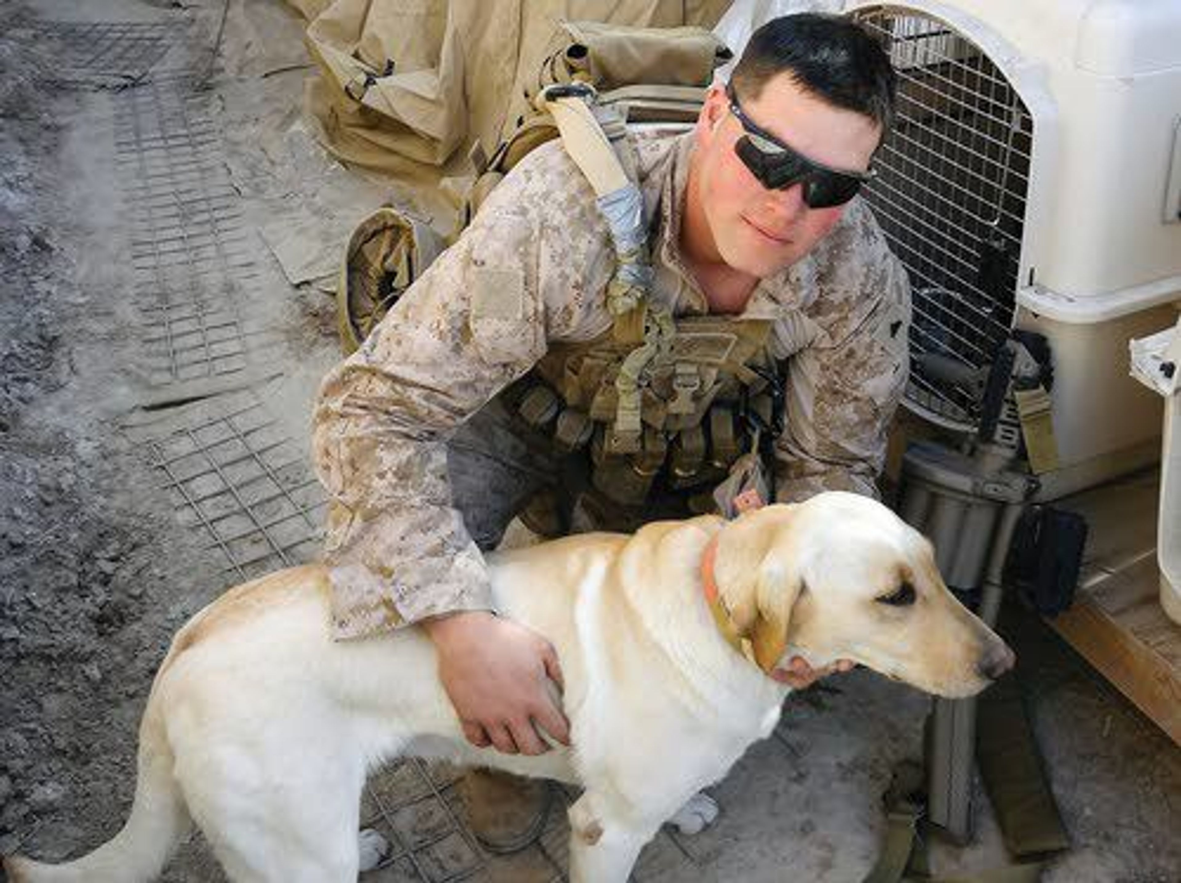 U.S. Marine Nick Montez and his bomb-sniffing dog, Mally, pose for a photo before going on an urban clearing operation while serving in Afghanistan in 2012.