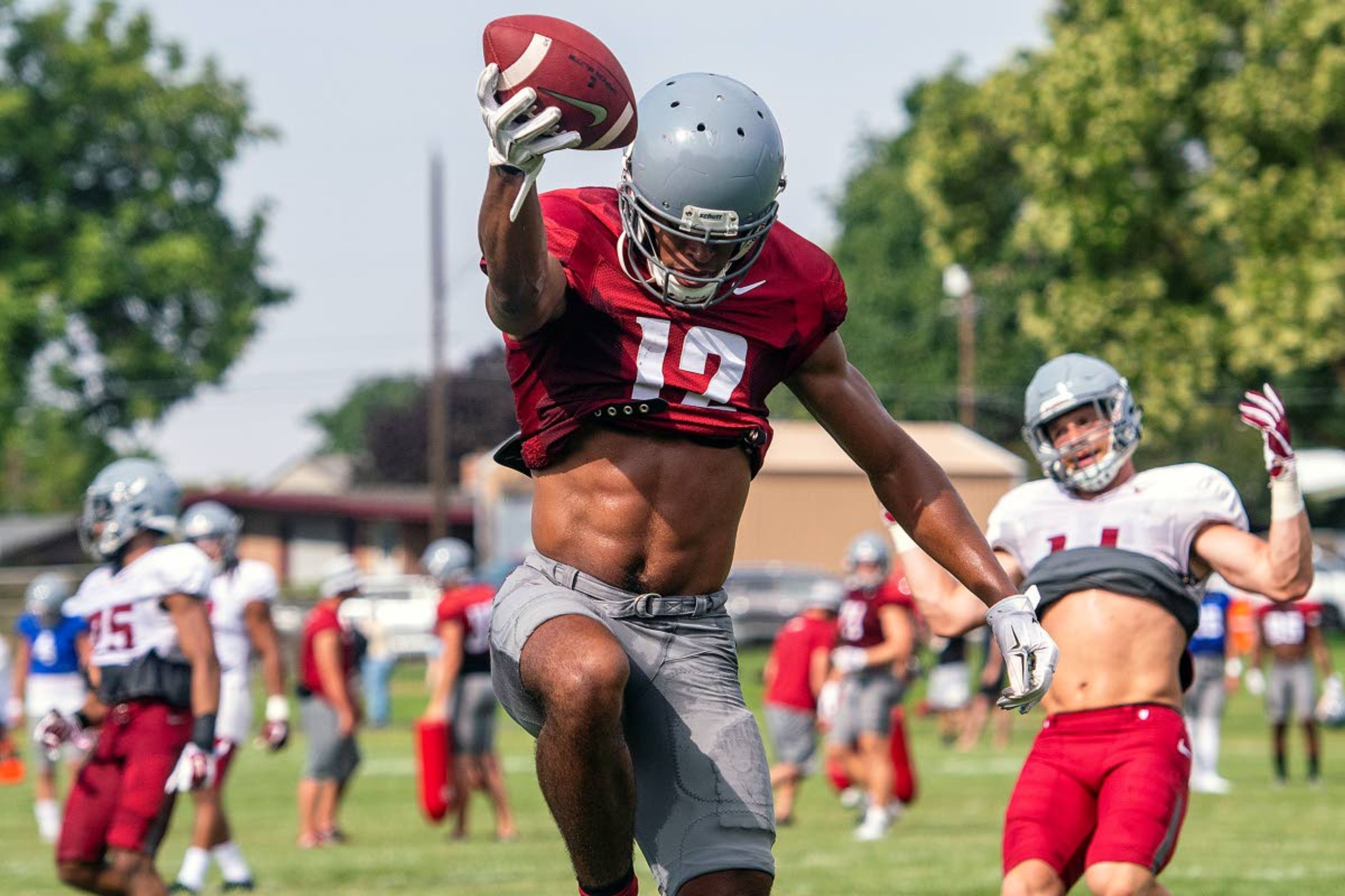 Washington State receiver Dezmon Patmon celebrates as he leaps into the end zone for a touchdown to the Cougar defense's dismay during team drills on Tuesday in Lewiston.