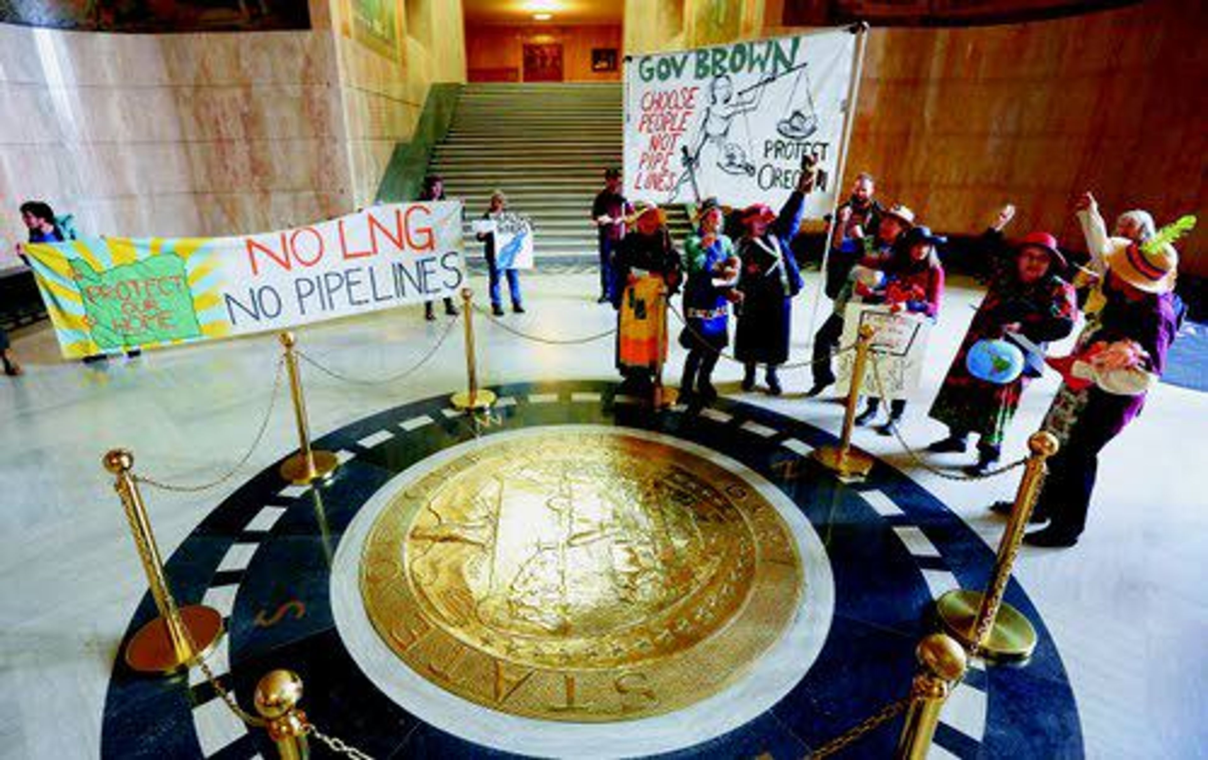 In this photo taken Oct. 19, 2015, Raging Grannies of Oregon sing songs to protest the Jordan Cove Liquefied Natural Gas export facility and Pacific Connector gas pipeline inside the Oregon Capitol in Salem, Ore.