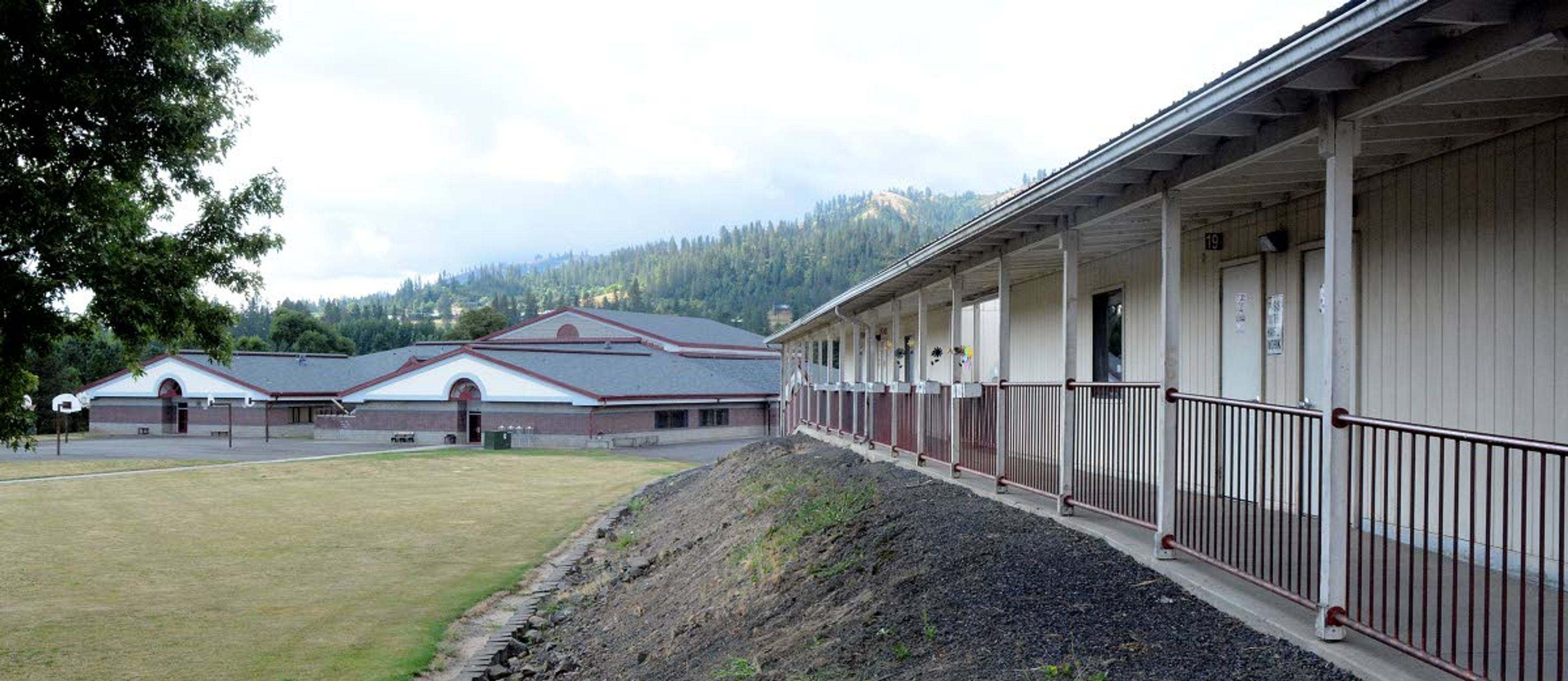 Some elementary school classes at Kamiah have been relocated to modular buildings (right) after a failed levy prompted cost-saving reorganization. The middle school, left, is closed for now.