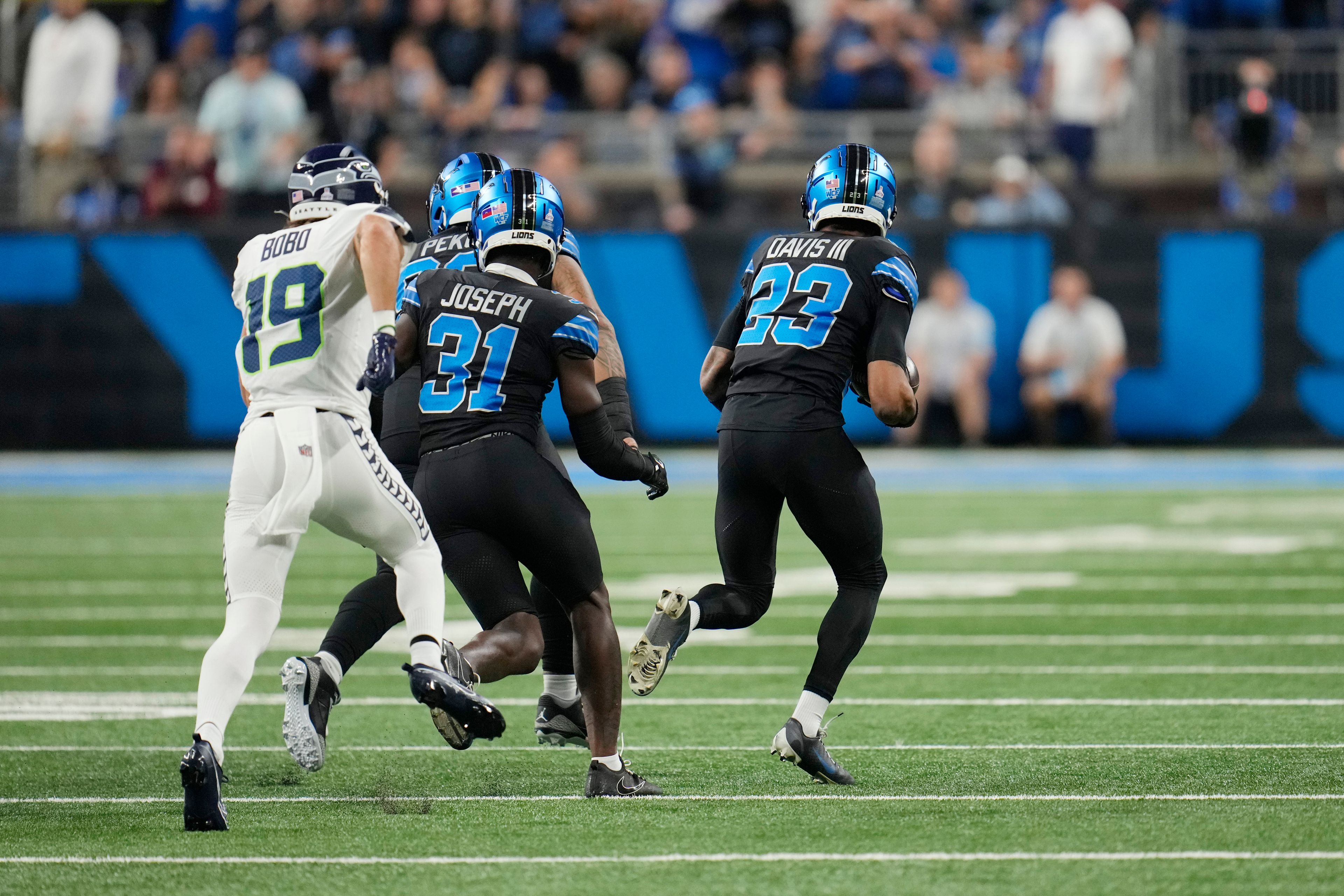 Detroit Lions cornerback Carlton Davis III (23) recovers a fumble from Seattle Seahawks wide receiver DK Metcalf and runs downfield during the first half of an NFL football game, Monday, Sept. 30, 2024, in Detroit. (AP Photo/Paul Sancya)