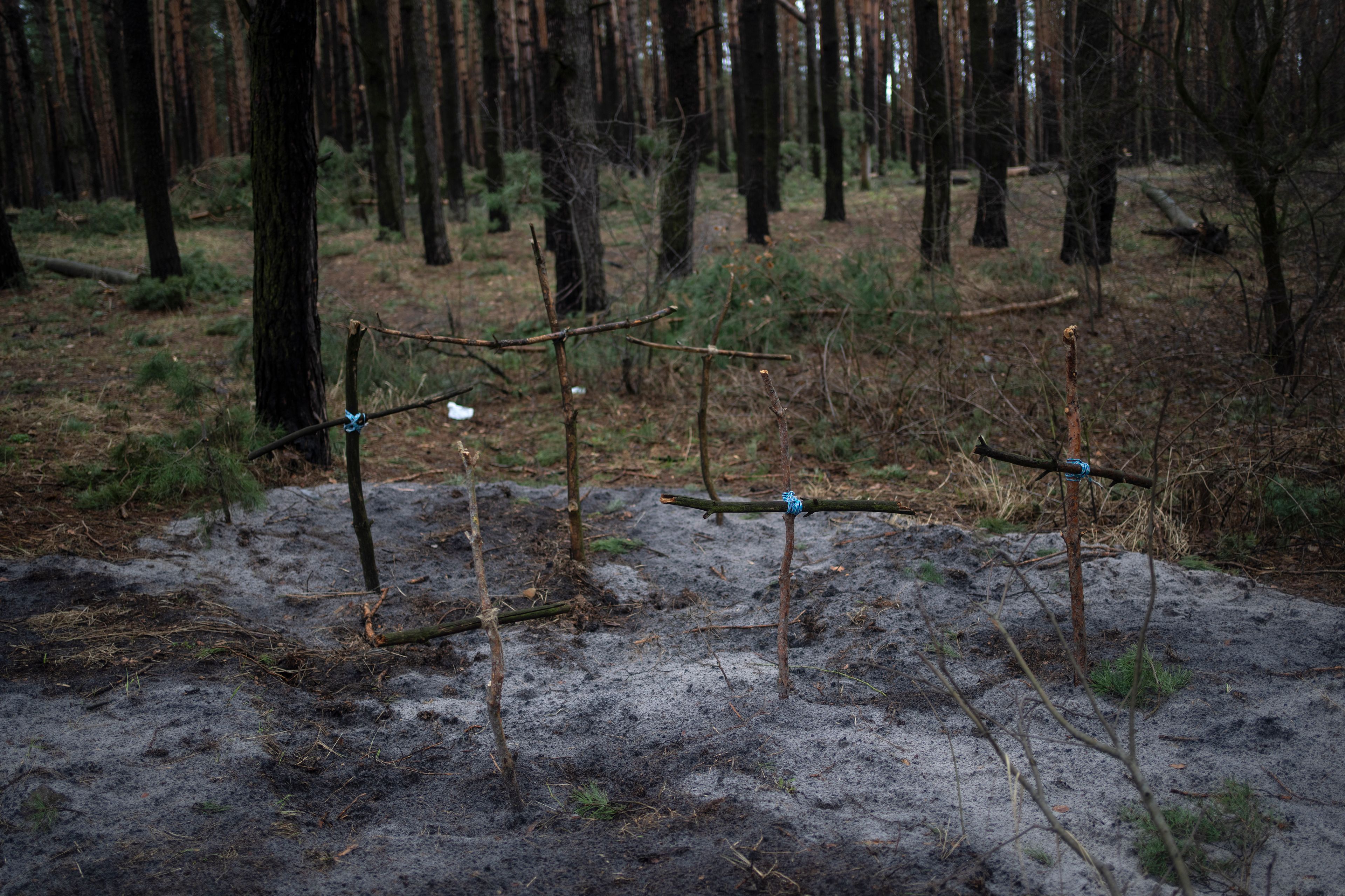 Crosses to honor civilians killed during the combats against Russia stand in the forest of Irpin, on the outskirts of Kyiv, Ukraine, Saturday, April 2, 2022. As Russian forces pull back from Ukraine’s capital region, retreating troops are creating a “catastrophic" situation for civilians by leaving mines around homes, abandoned equipment and “even the bodies of those killed," President Volodymyr Zelenskyy warned Saturday. (AP Photo/Rodrigo Abd)