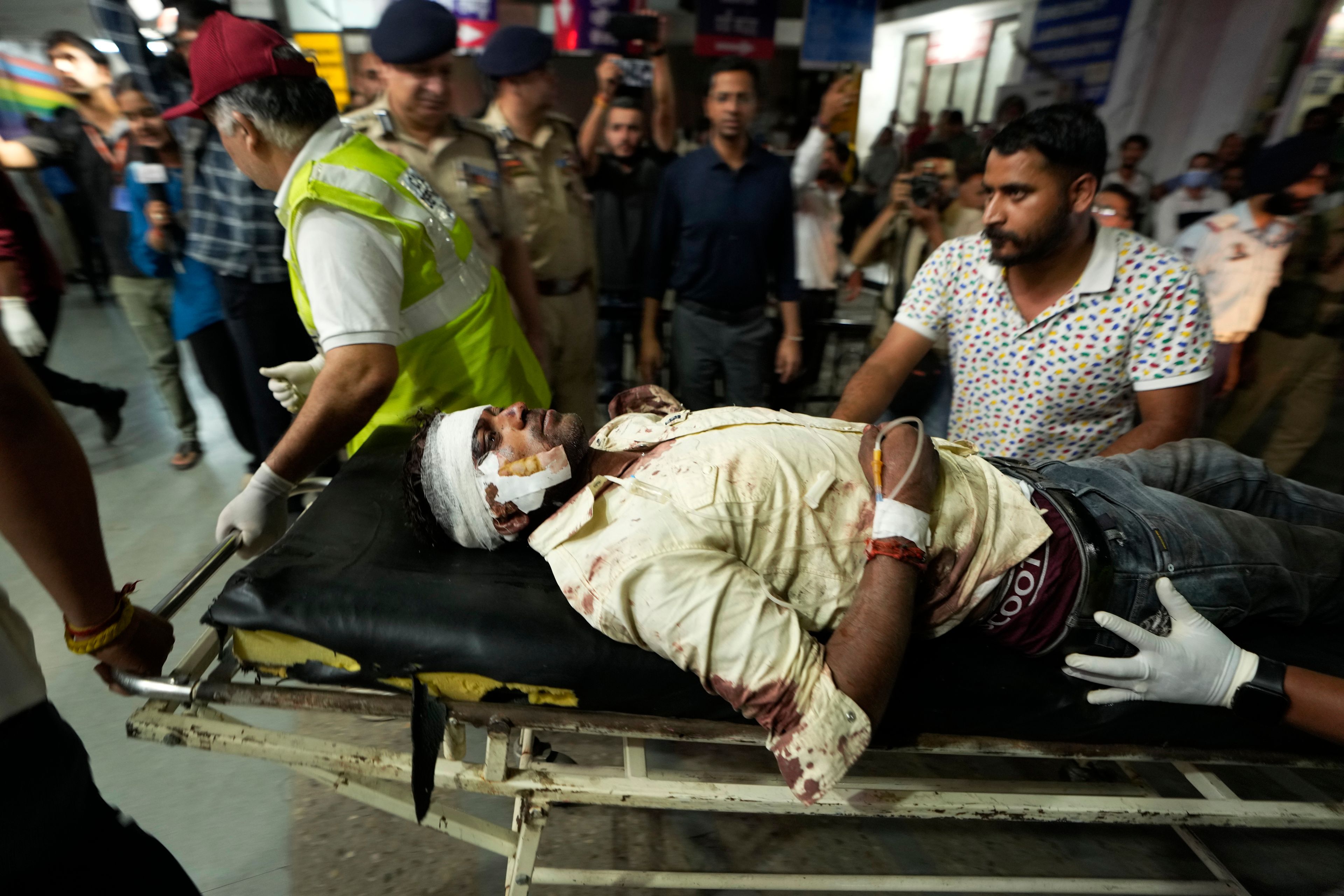 An injured man is brought to the Government Medical College Hospital in Jammu after the bus he was traveling in fell into a deep gorge in the Pouni area of Jammu's Reasi district, India, Sunday, June 9, 2024. Officials in Indian-controlled Kashmir say at least nine people have been killed after suspected militants fired at a bus with Hindu pilgrims, which then fell into a deep gorge.