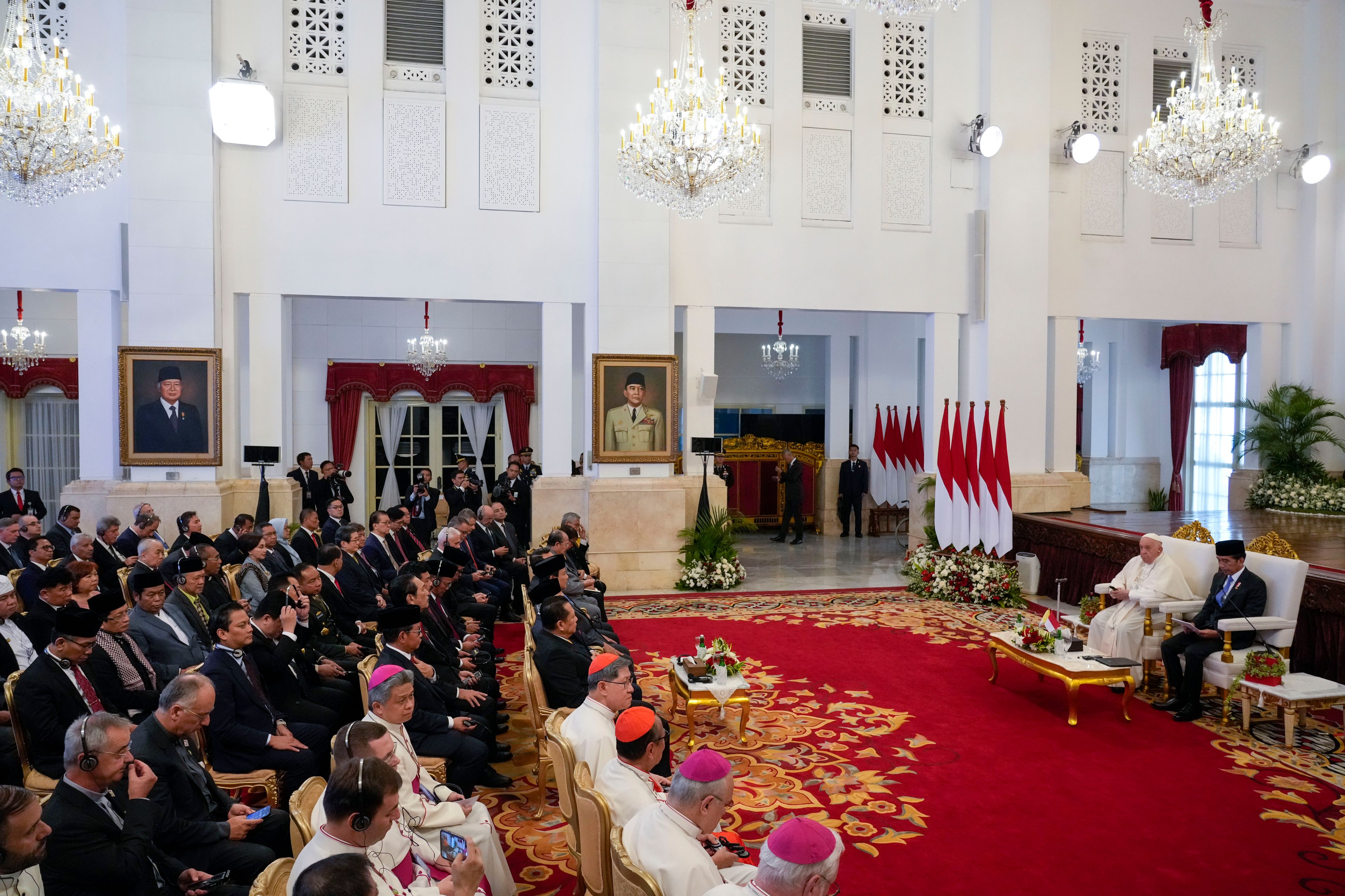 Pope Francis and Indonesian President Joko Widodo, right, attend a meeting with Indonesian authorities and Ambassadors at Istana Merdeka Presidential Palace in Jakarta, Wednesday, Sept. 4, 2024. Pope Francis is opening his visit to Indonesia with a meeting at the presidential palace where he is expected to press his hopes for continued interfaith harmony in a country with a tiny Catholic minority and the world's largest Muslim population.