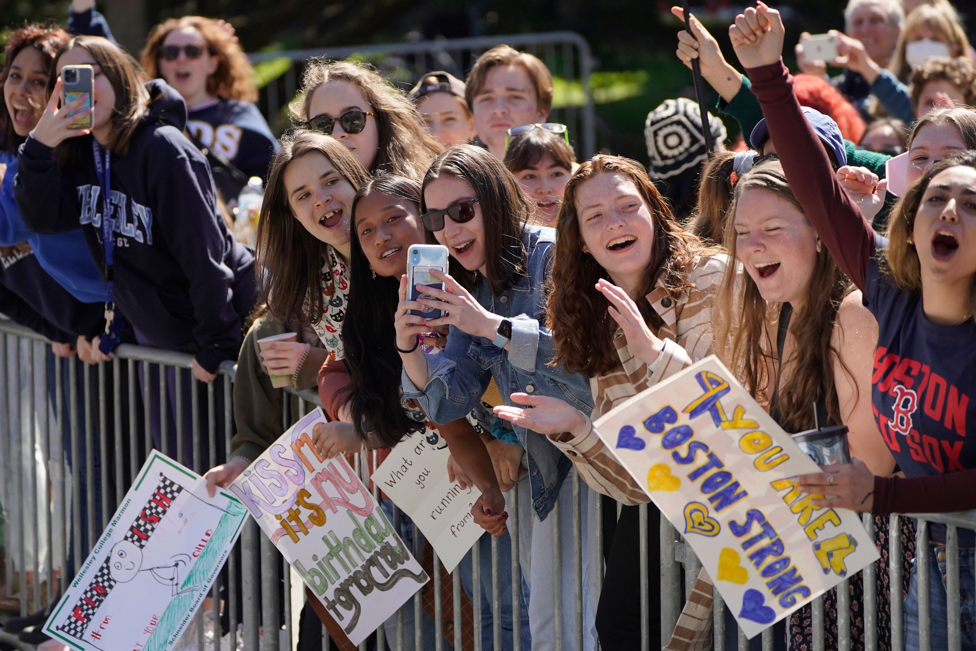 People cheer in front of Wellesley College, in Wellesley, Mass., as a runner passes during the 126th Boston Marathon, Monday, April 18, 2022. (AP Photo/Steven Senne)