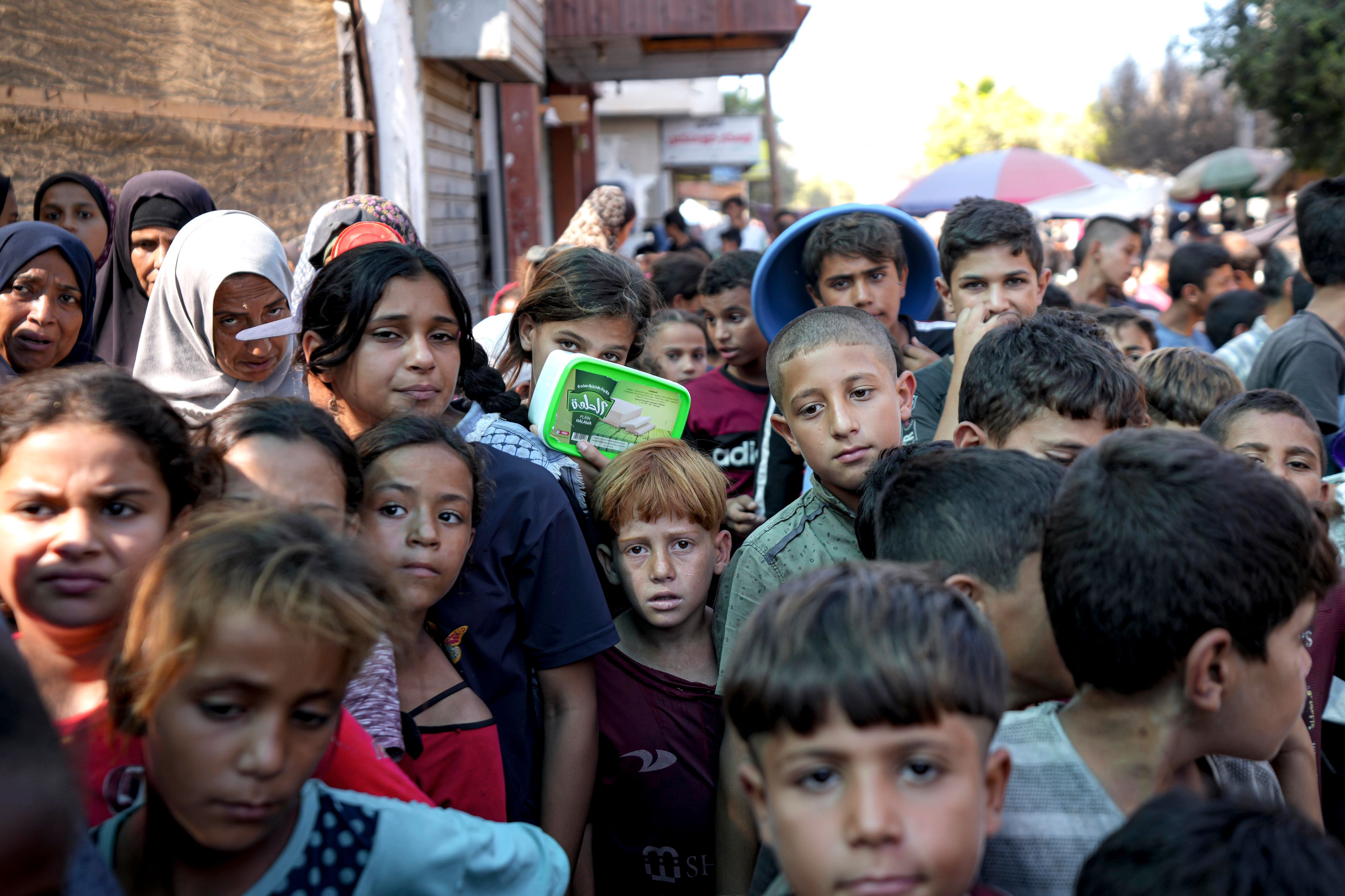 FILE - Palestinians line up for food distribution in Deir al-Balah, Gaza Strip, on Oct. 17, 2024. (AP Photo/Abdel Kareem Hana, file)