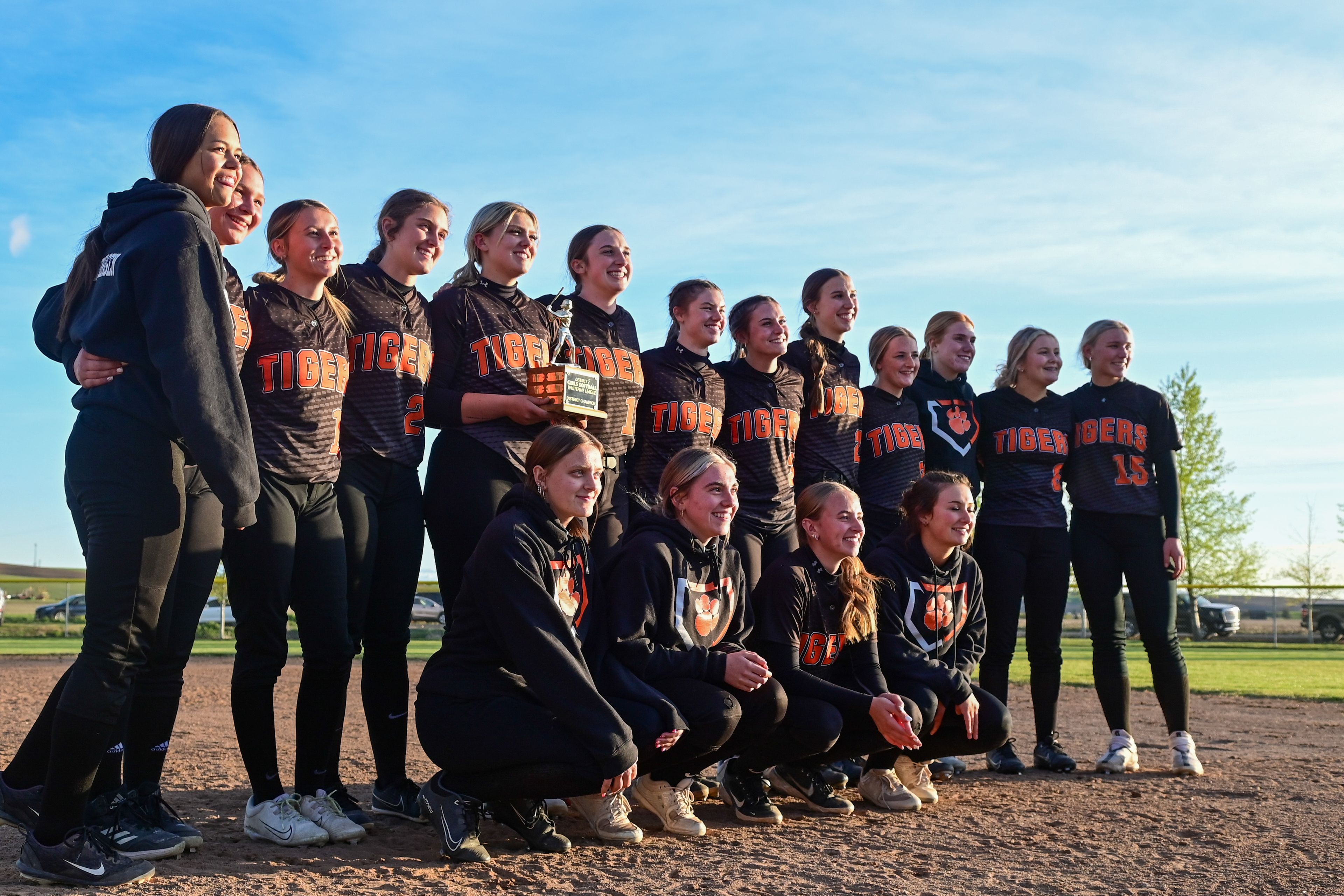 Kendrick players pose for a photo with the championship trophy after their win over Genesee in an Idaho 2A district tournament championship game Wednesday in Genesee.