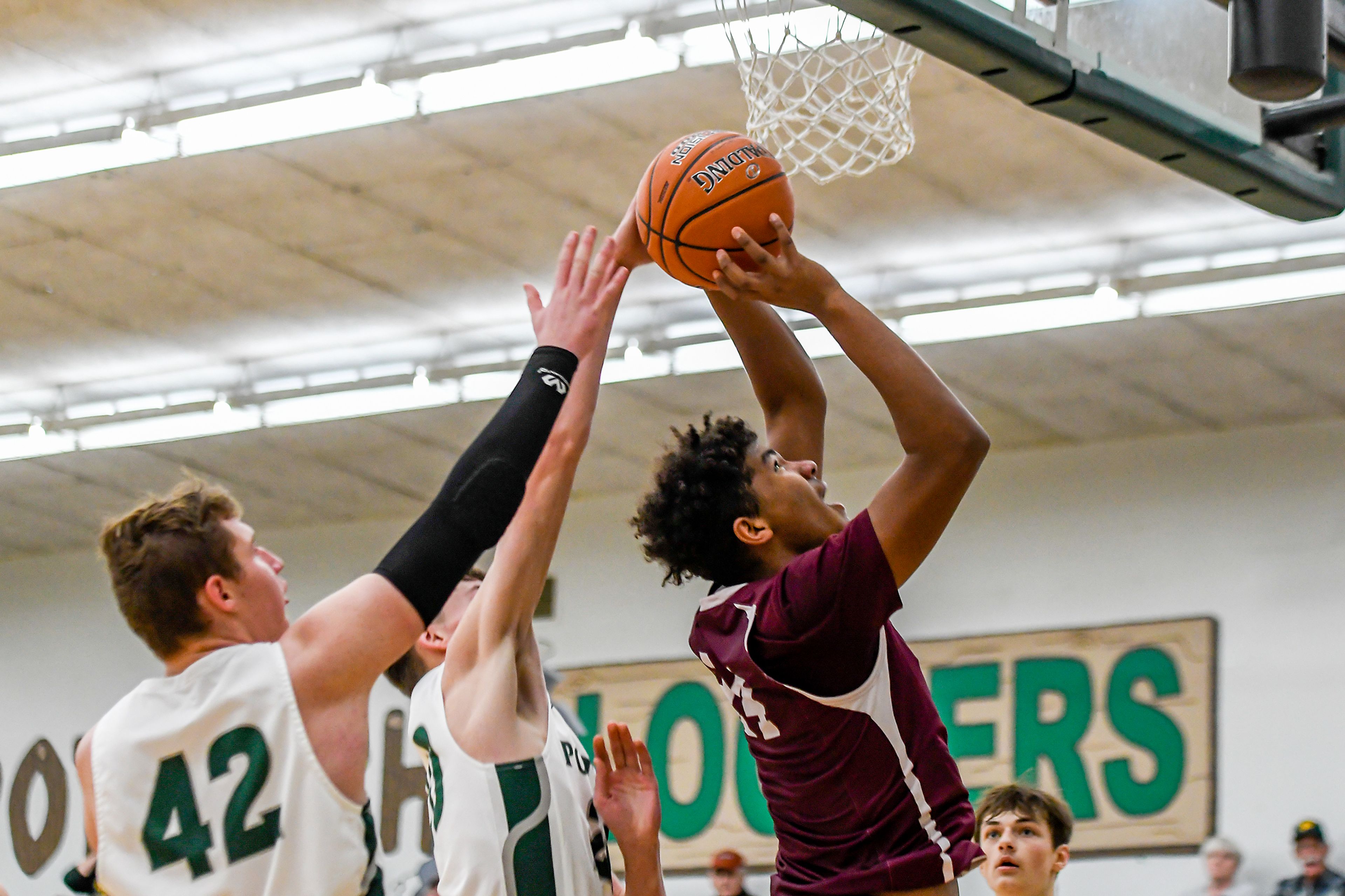 Kamiah center Rehan Kou, right, shoots as Potlatch forward Jaxon Vowels defends during Saturday's Whitepine League Division I boys basketball game.