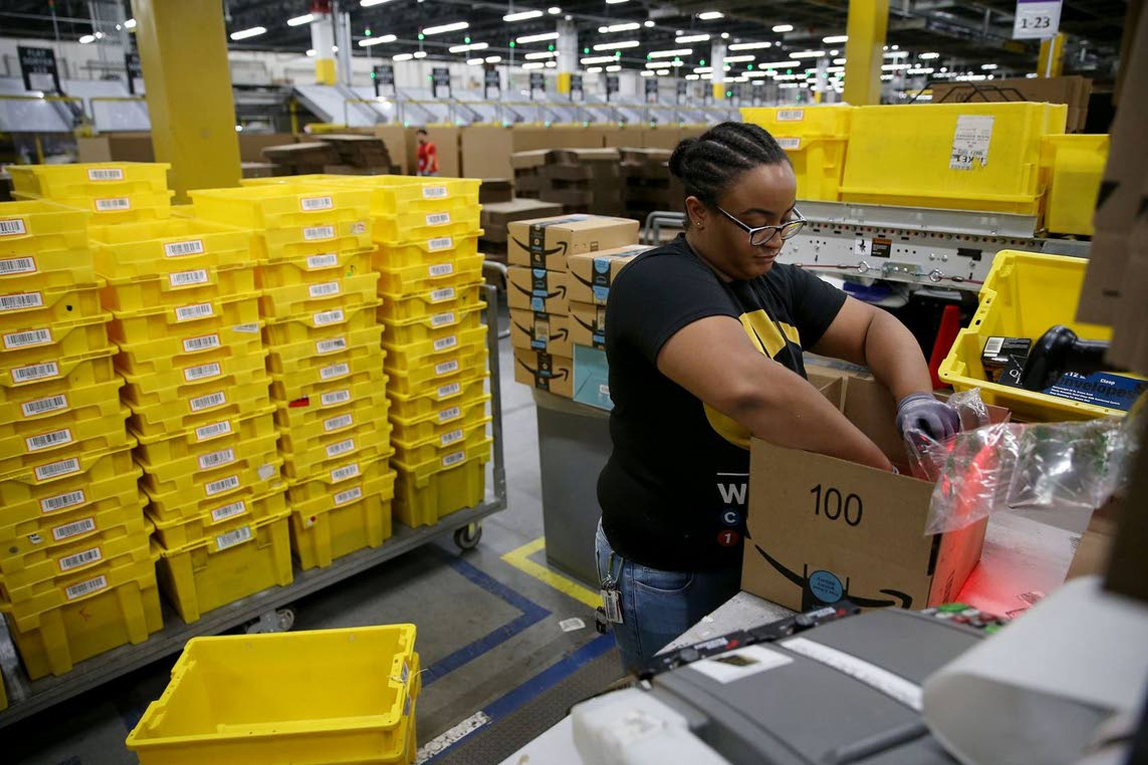 Tyleira Thompson boxes up an order to be shipped at the Amazon Fulfillment Center in West Deptford, N.J., on June 14. The robotic fulfillment center opened in September and is Amazon's fourth such site in New Jersey.