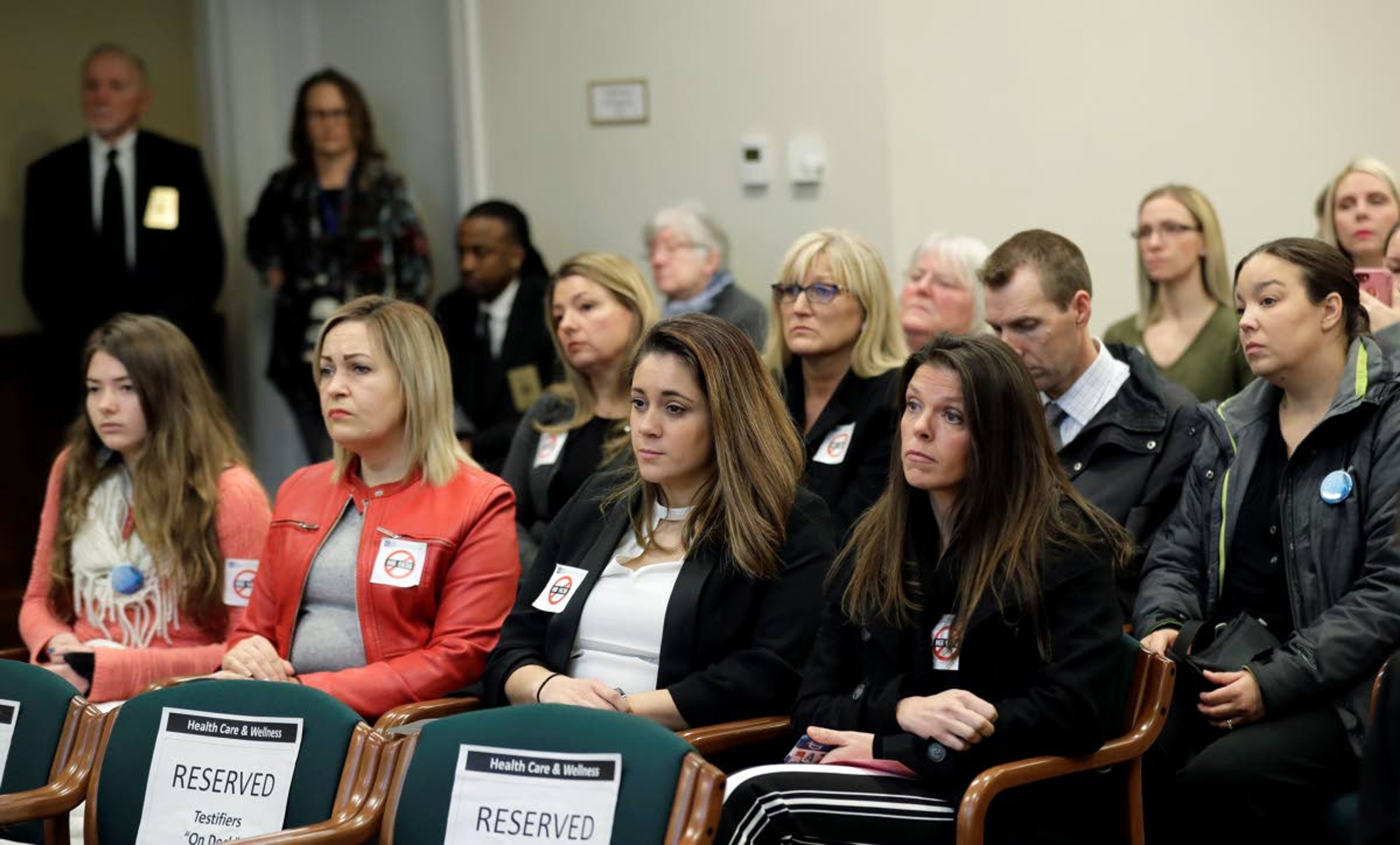 People opposed to a bill that would remove parents' ability to claim a philosophical exemption to opt their school-age children out of the combined measles, mumps and rubella vaccine listen to testimony Friday, Feb. 8, 2019, during a public hearing before the House Health Care & Wellness Committee at the Capitol in Olympia, Wash. Amid a measles outbreak that has sickened people in Washington state and Oregon, lawmakers heard public testimony on the bill Friday. (AP Photo/Ted S. Warren)