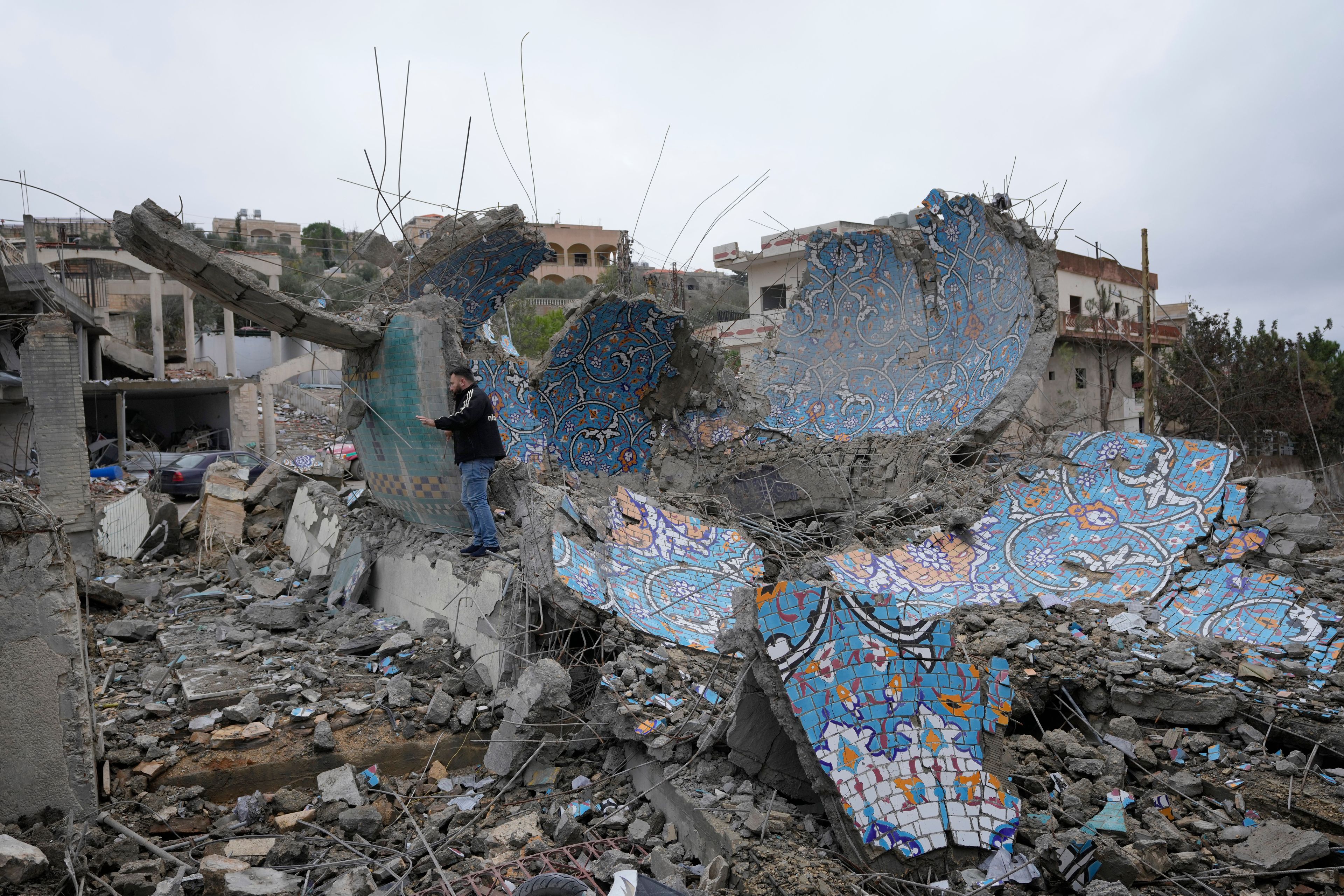 A man checks a destroyed mosque, following a ceasefire between Israel and Hezbollah that went into effect on Wednesday, Nov. 27, 2024, in Ainata village, southern Lebanon. (AP Photo/Hussein Malla)