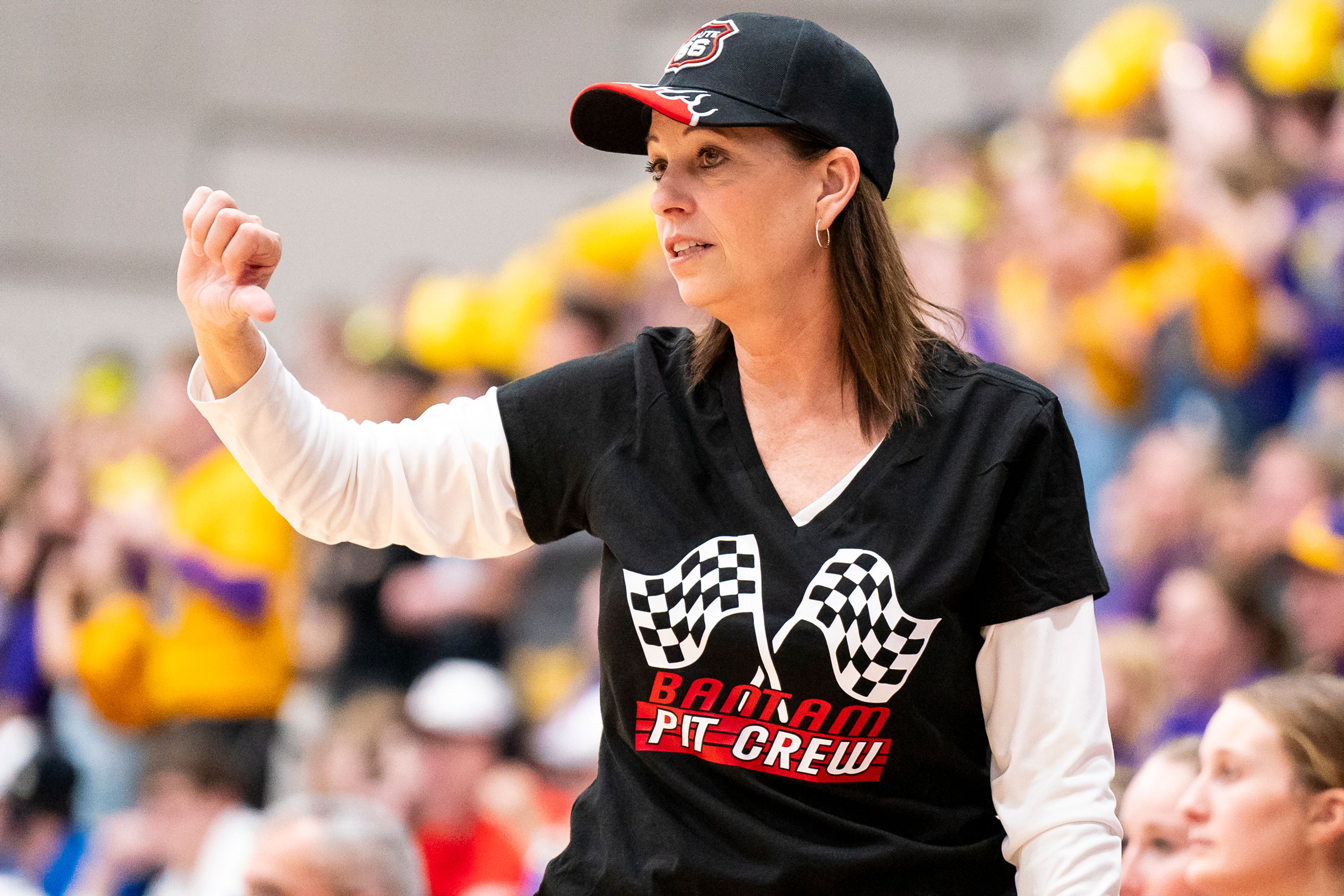 Clarkston girls basketball head coach Debbie Sobotta shows her school spirit as she calls a play during their Golden Throne rivalry game against Lewiston on Friday inside the P1FCU Activity Center in Lewiston.