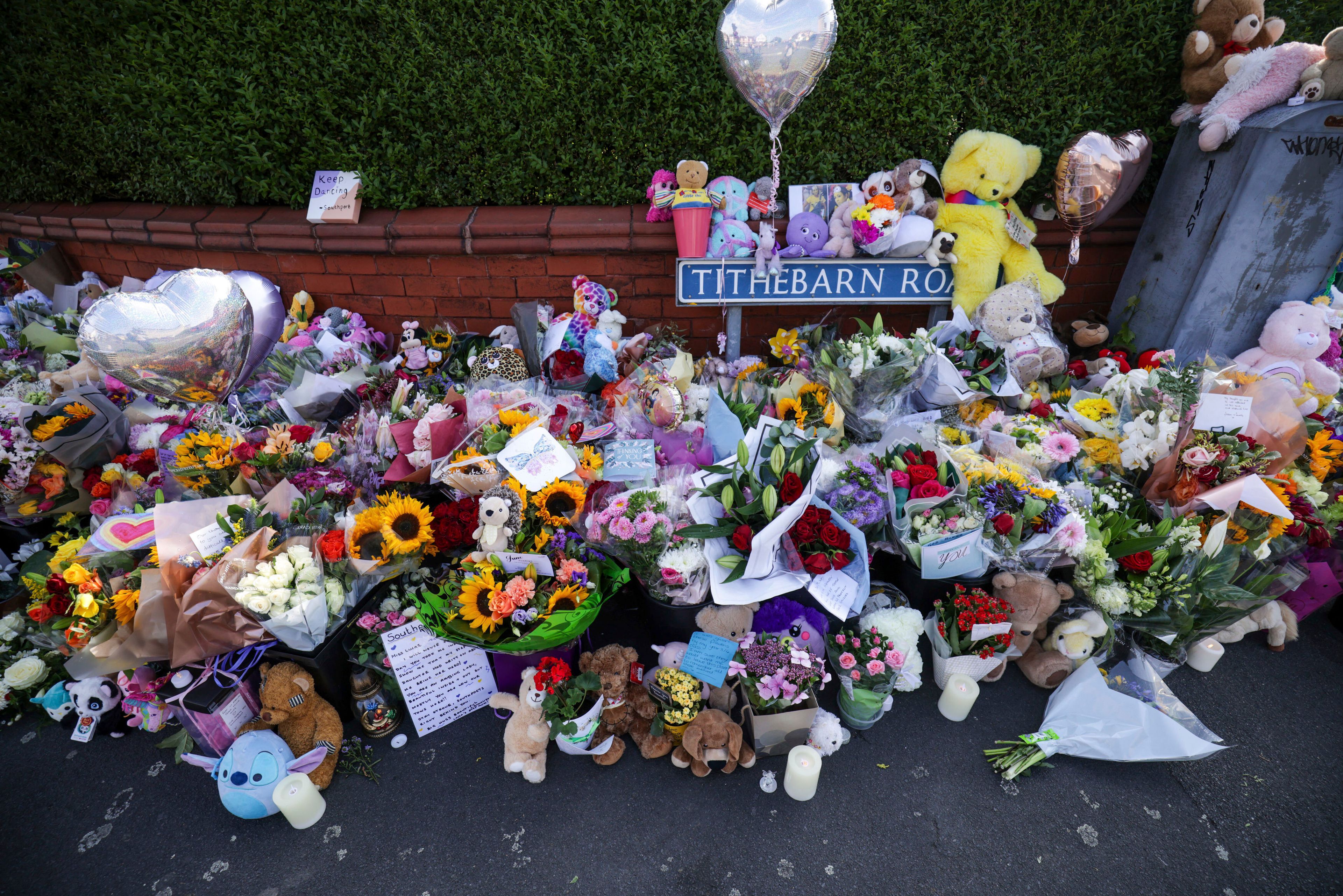 Flowers and toys are placed on the junction of Tithebarn Road and Hart Street in Southport, England, Wednesday, July 31, 2024, after three girls killed in a knife attack at a Taylor Swift-themed holiday club on Monday. (James Speakman/PA via AP)