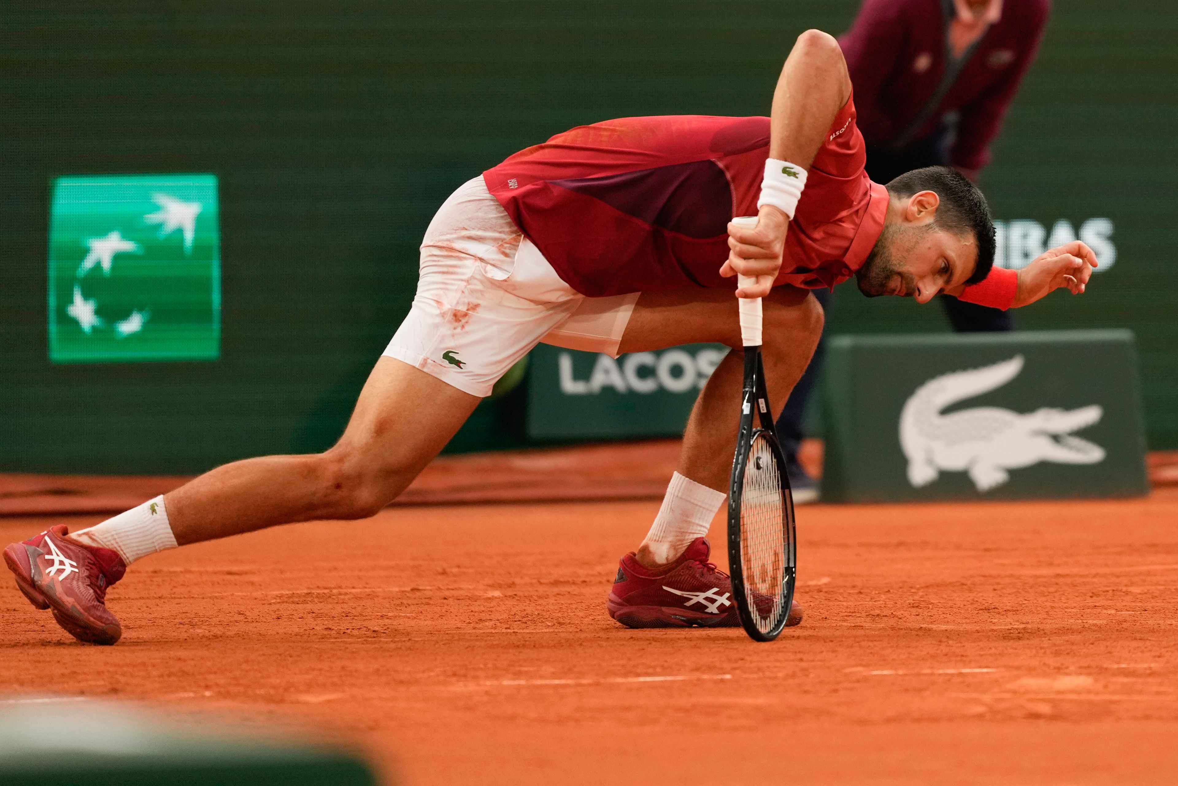 FILE - Serbia's Novak Djokovic slipped during his fourth round match of the French Open tennis tournament against Argentina's Francisco Cerundolo at the Roland Garros stadium in Paris, Monday, June 3, 2024. Novak Djokovic withdrew from the French Open with an injured right knee on Tuesday, June 4, 2024, ending his title defense and meaning he will relinquish the No. 1 ranking.