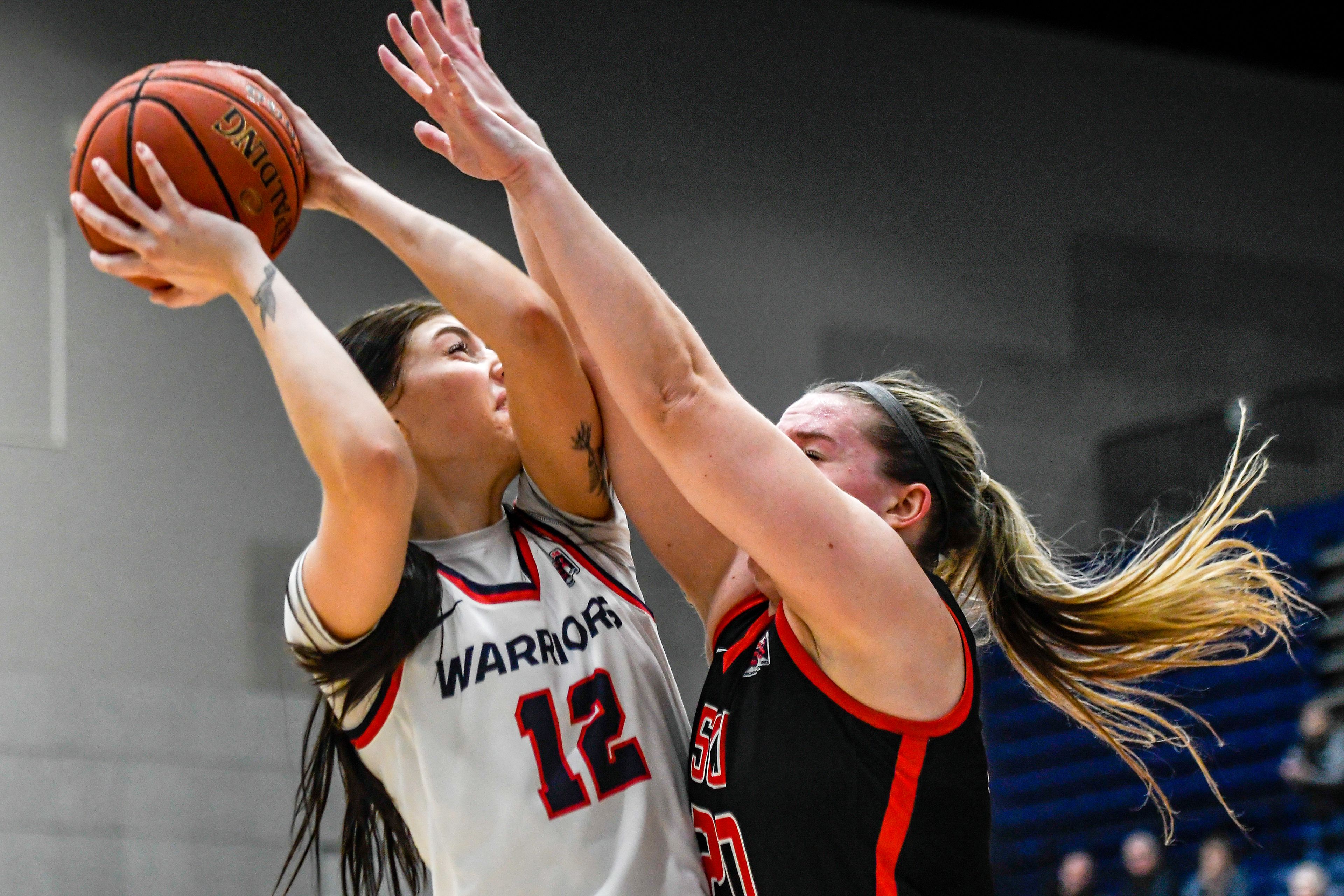 Lewis-Clark State post Sara Muehlhausen, left, shoots during Saturday's Cascade Conference game against Southern Oregon at the P1FCU Activity Center.