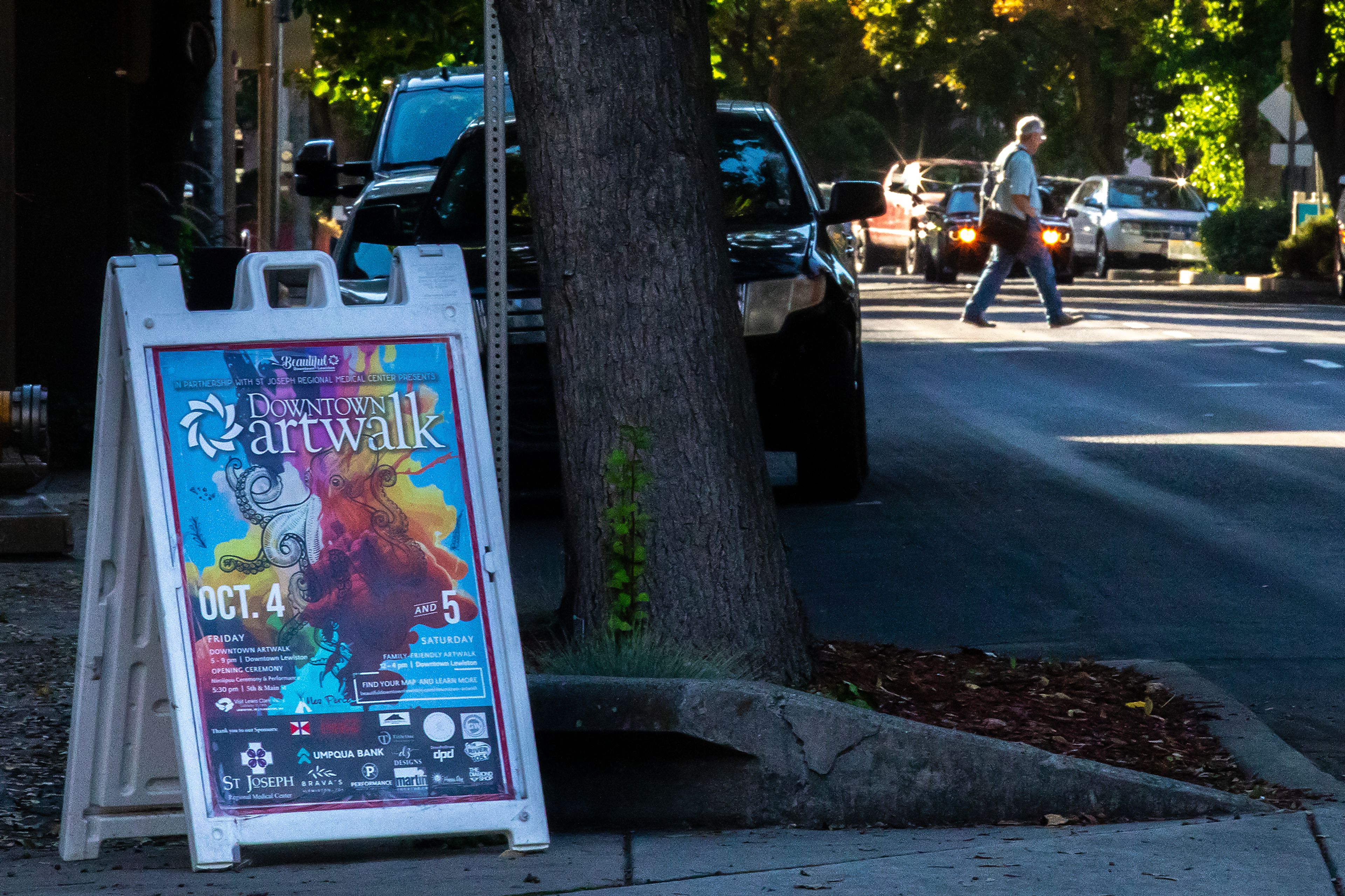 A person crosses Main Street as a sign for the Downtown Artwalk is pictured Friday, Sept. 27, in Lewiston.,