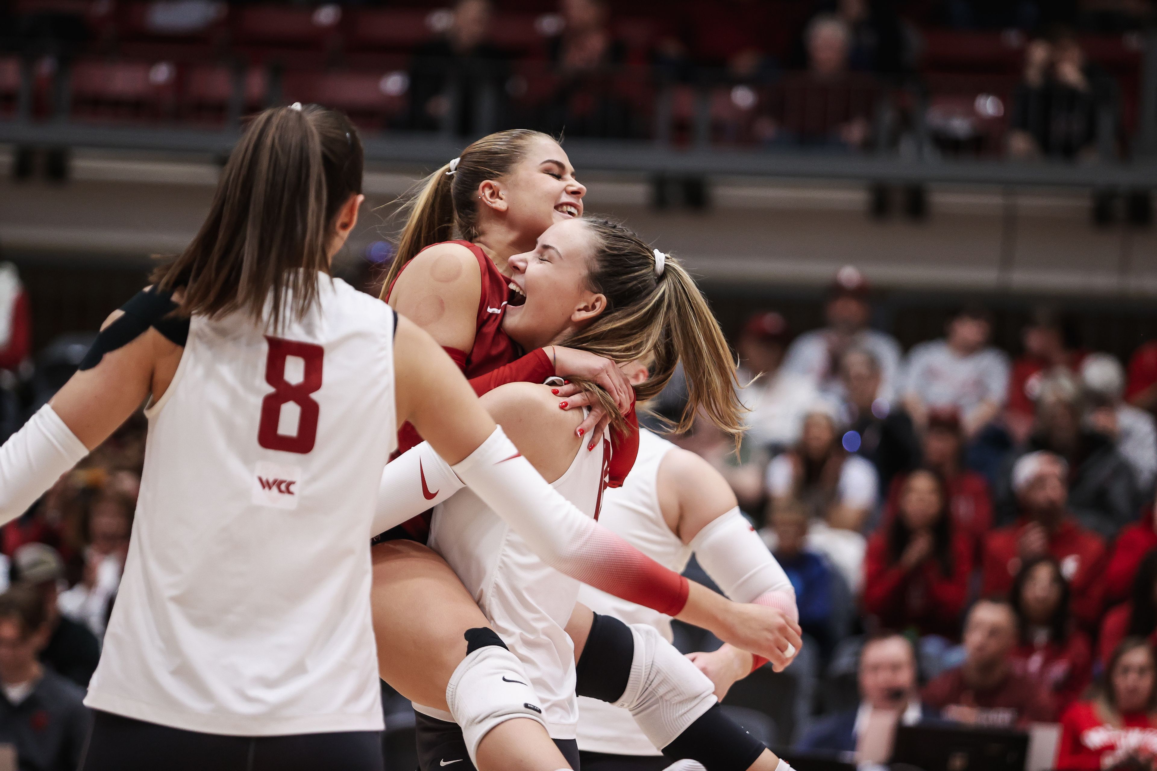 Washington State sophomore Emma Barbero leaps into WSU redshirt freshman Lucie Blažková’s arms as senior Katy Ryan looks on during WSU’s match versus Oregon State on Thursday at Bohler Gym in Pullman.
