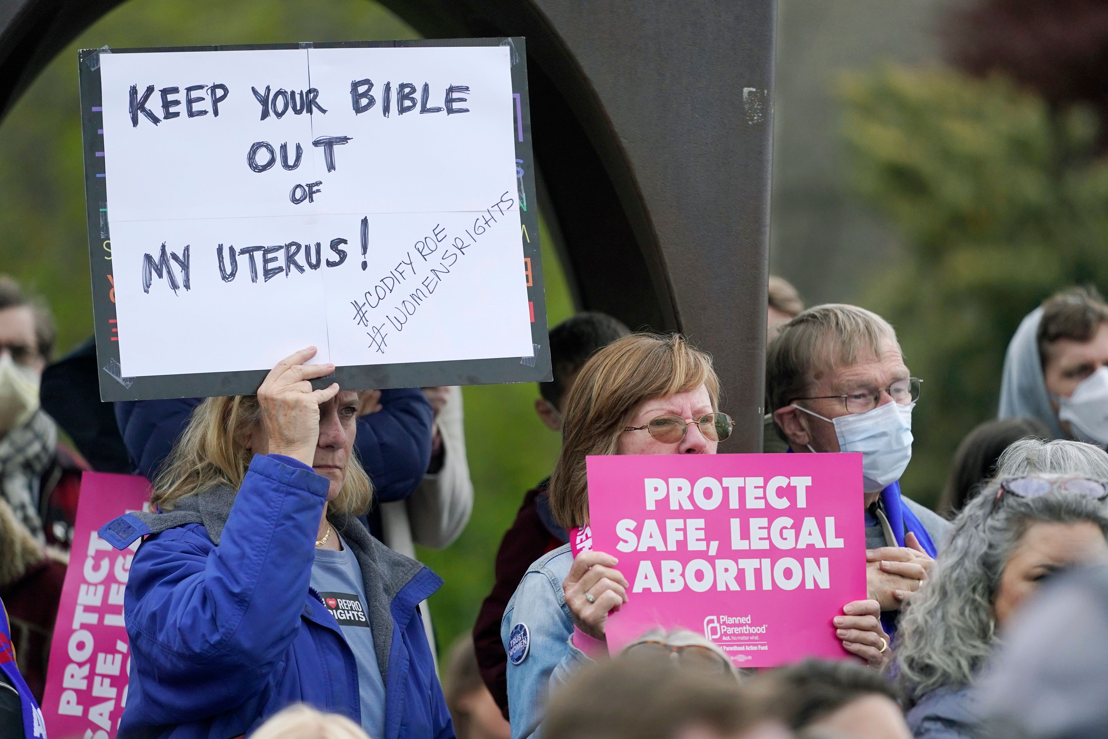 A person holds a sign that reads "Keep Your Bible out of My Uterus!", Tuesday, May 3, 2022, during a rally at a park in Seattle in support of abortion rights. (AP Photo/Ted S. Warren)