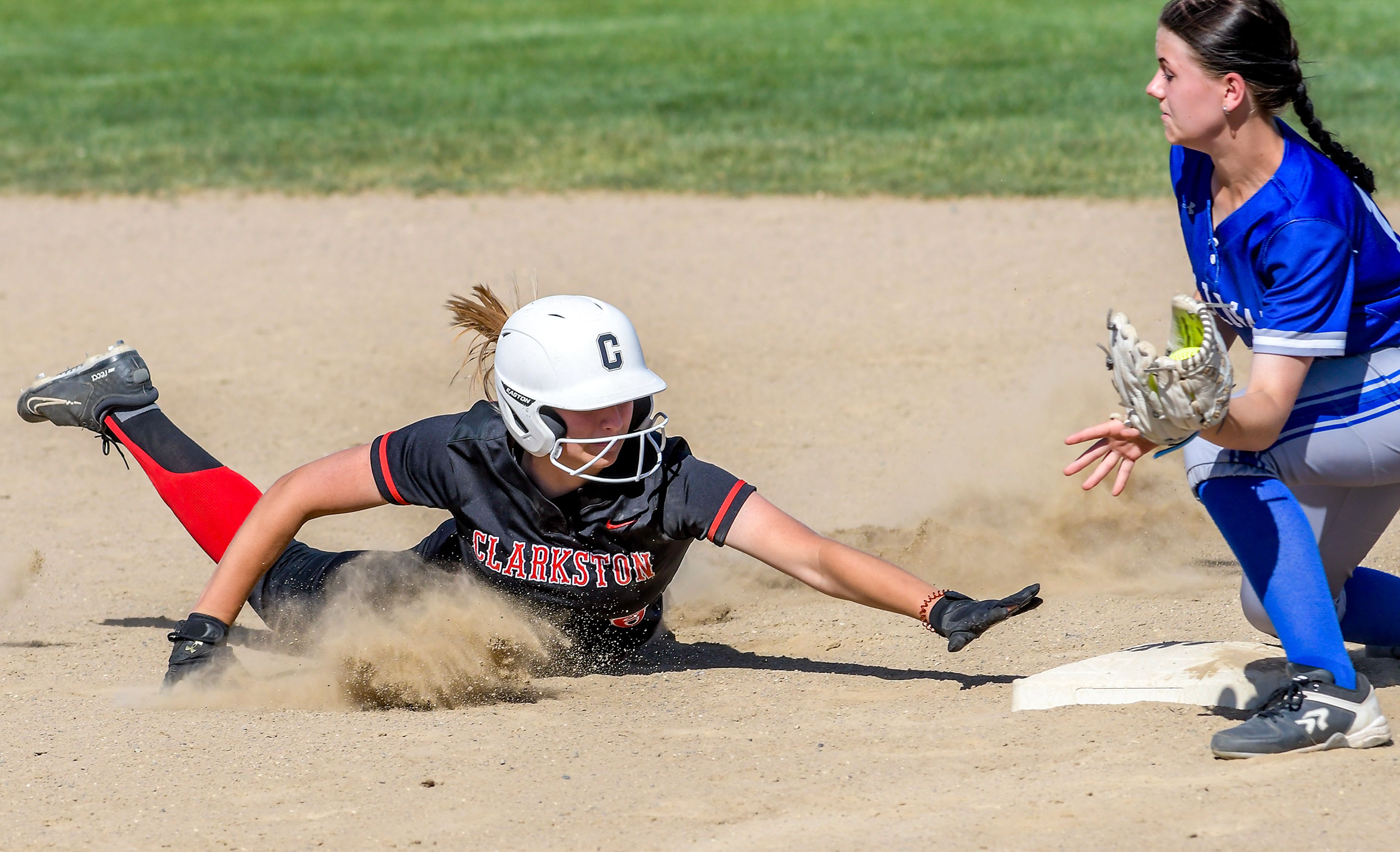 Clarkston’s Brooke Blaydes dives back to second base as Pullman second baseman Sammi Turner looks to tag her in an inning of a district tournament semifinal round game Thursday in Clarkston.