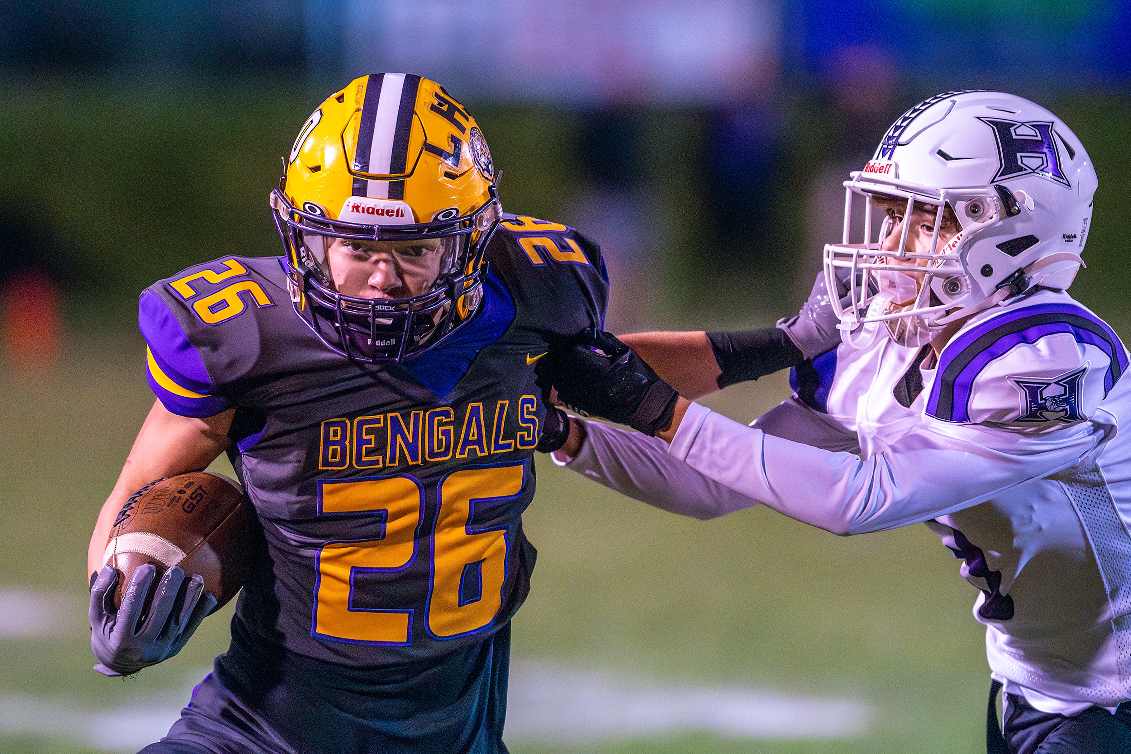 Lewiston running back Sawyer Casey stiff arms Hermiston defensive back Tanner Wicks during a nonconference game at Bengal Field Friday in Lewiston.,